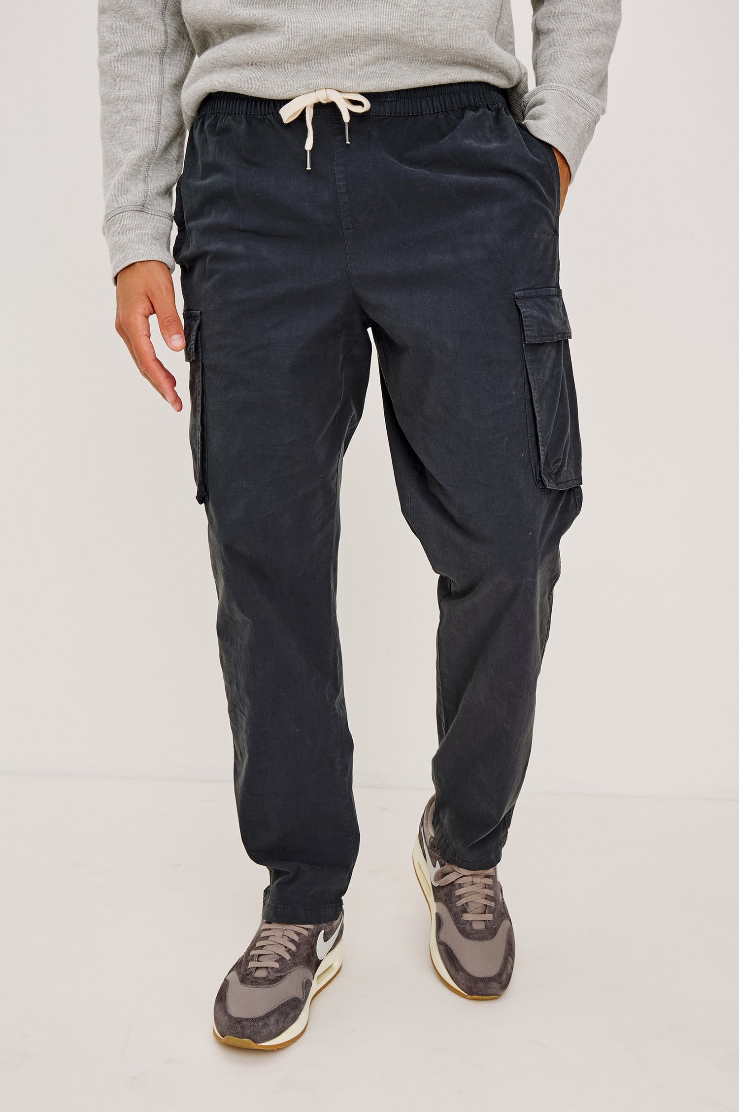 Emmerson Pant in Lightweight Cotton With Cargo Pockets and Drawstring Waist in Washed Black Colorway - Lower Body Front View Featured on Model