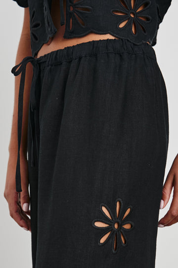Emmie Pants with a Drawstring Waist and Two Front Pockets in Black Eyelet Colorway, with eyelets along the outer and inner sides  - Front View Featured on Model