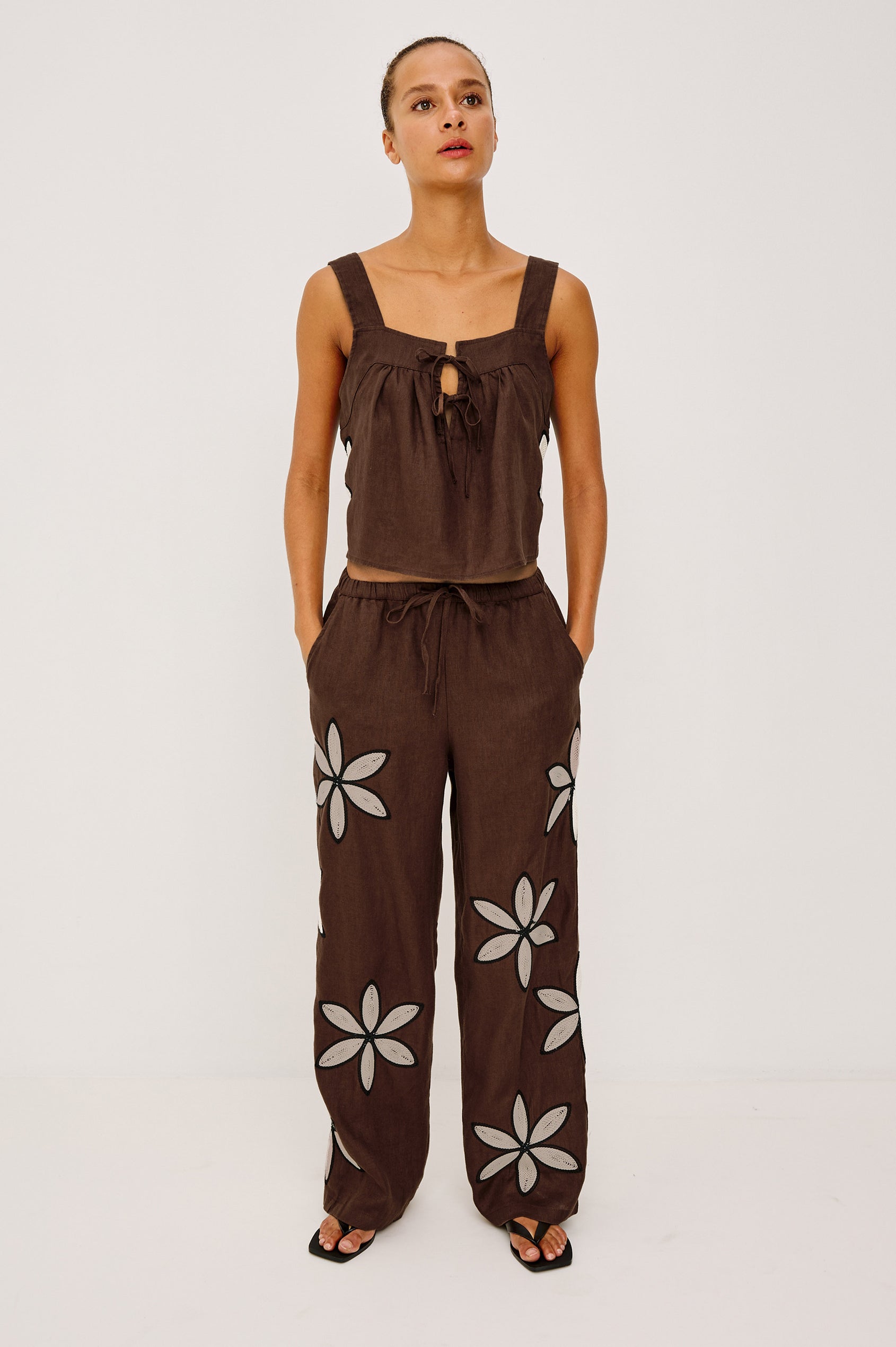 Emmie Straight Leg Pant in Unlined Linen With Adjustable Drawstring Waist Ties and Side Pockets in Cocoa Floral Embroidery Colorway — Full Body Front View Featured on Model