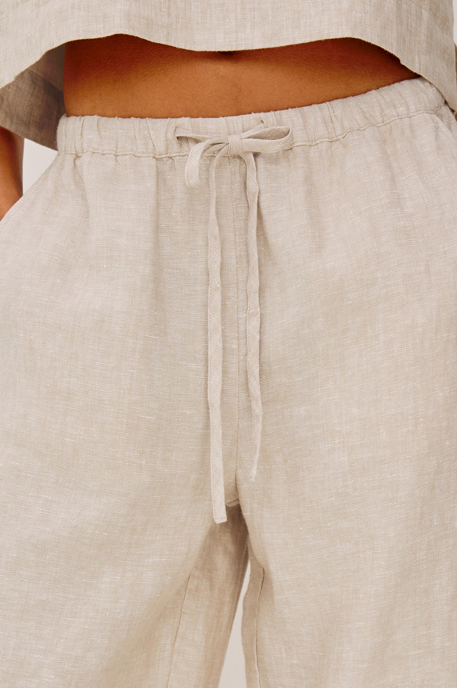 Emmie Crop Pant in Linen With Straight Legs, Adjustable Drawstring Waist Ties, and Side Pockets in Heathered Flax Colorway - Lower Body Front View Featured on Model