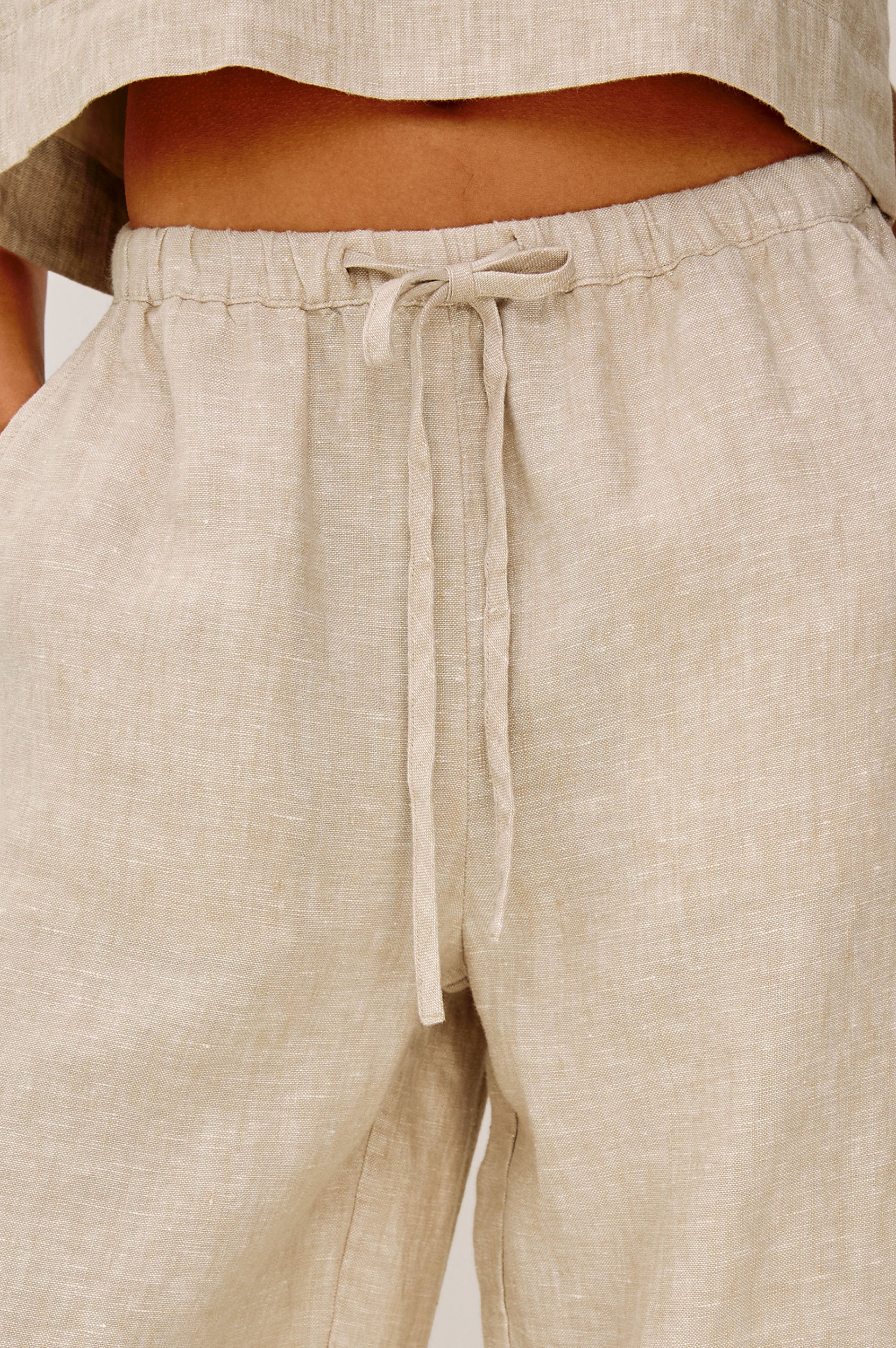 Emmie Crop Pant in Linen With Straight Legs, Adjustable Drawstring Waist Ties, and Side Pockets in Heathered Flax Colorway - Lower Body Front View Featured on Model