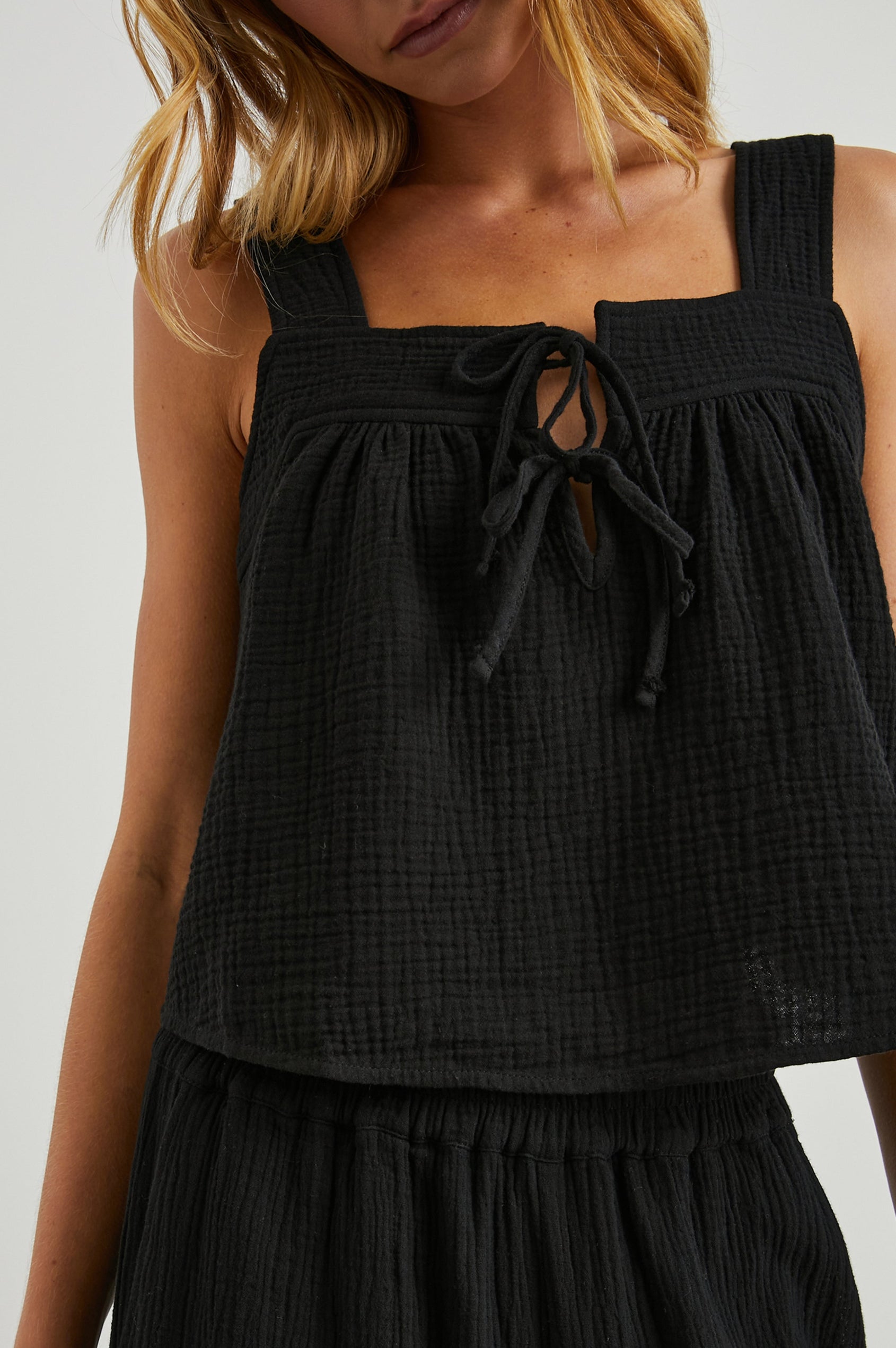 Enya Cropped Tank Top with a Square Neck with a V Cutout with Ties in Black Gauze Colorway - Front View Featured on Model
