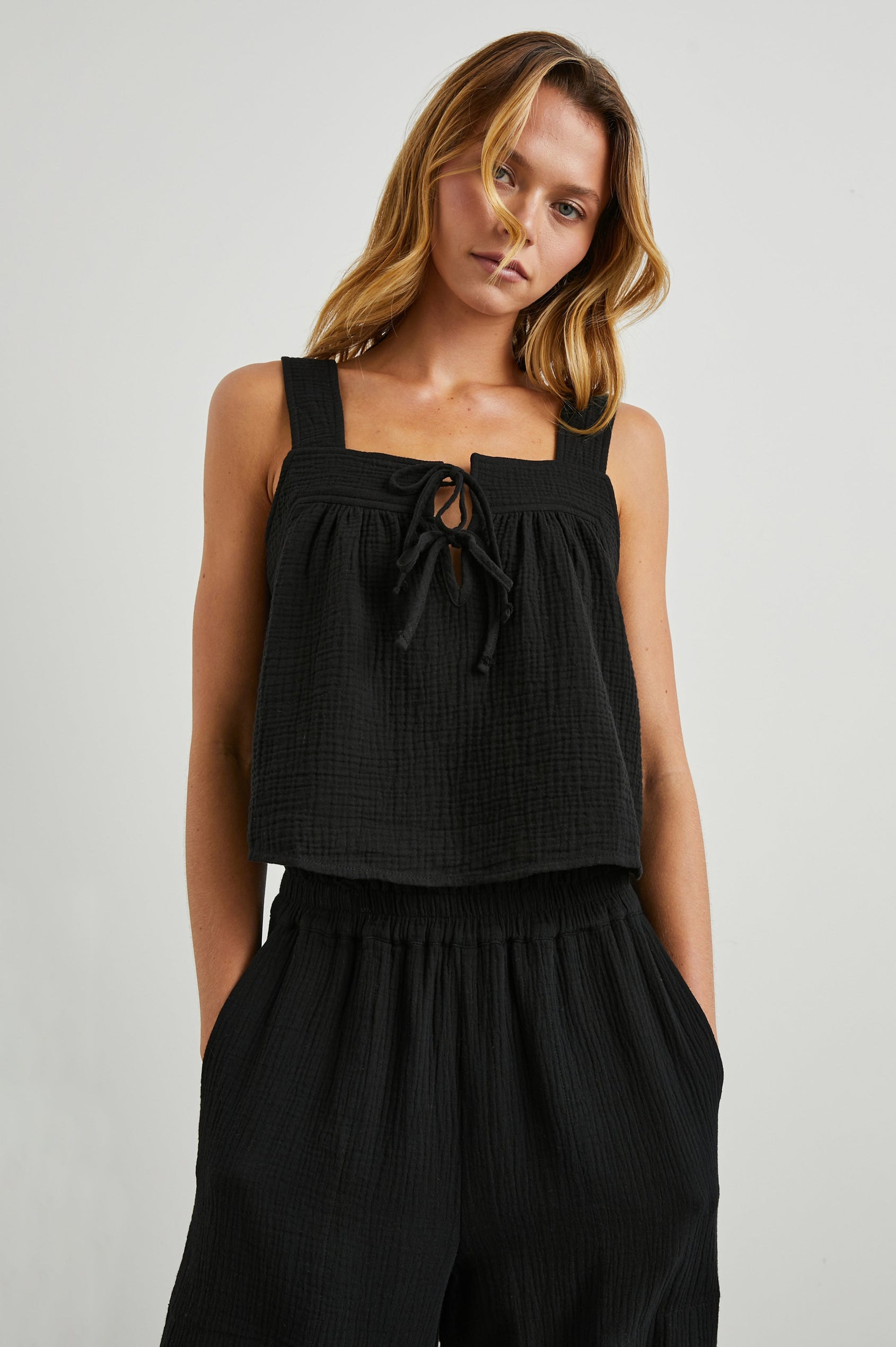 Enya Cropped Tank Top with a Square Neck with a V Cutout with Ties in Black Gauze Colorway - Front View Featured on Model