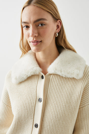 Esme Long-Sleeve Ribbed Sweater with Front Button Closure and a Faux Fur Collar in Ivory Colorway - Front View Featured on Model 