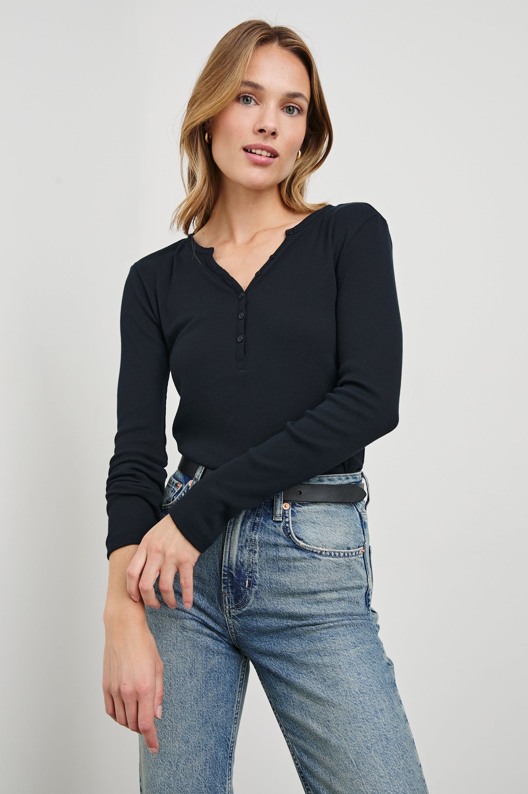 Essential Long-Sleeve Finely Ribbed Henley, with a V Neck and a Placket with Buttons in Black Colorway - Front Tucked View Featured on Model 