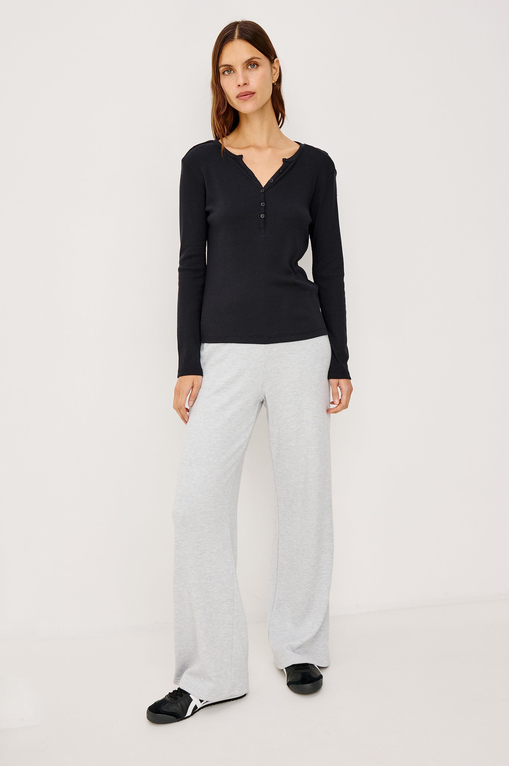 Essential Ribbed Henley With Front Placket and Long Sleeves in Black Colorway - Full Body Front View Featured on Model