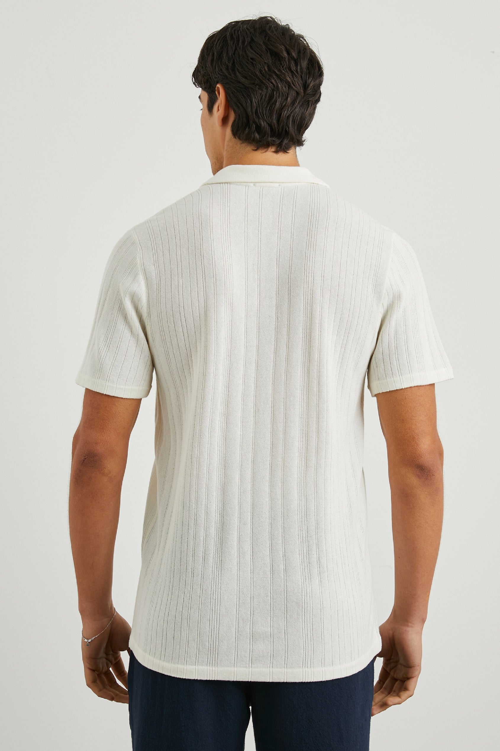 Etanne Short Sleeve Polo Shirt with a Buttonless Placket and Textured Vertical Stripes in Ecru Colorway - Back View Featured on Model