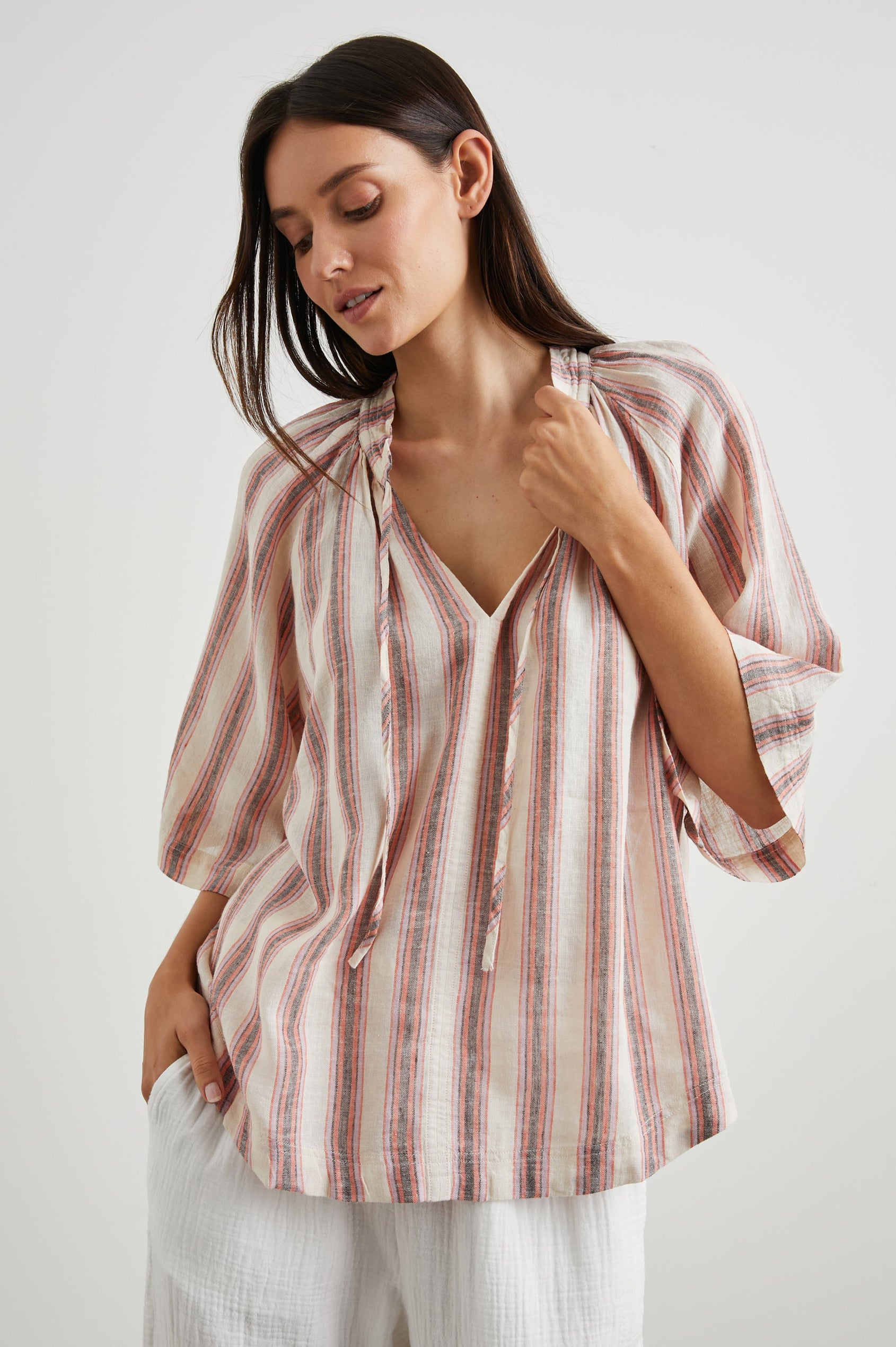Eveline Top with Elbow Length Sleeves a Deep V Neck with a Drawstring in Camino Stripe Colorway, Vertical Orange, Brown and Purple Stripes on Cream - Front View Featured on Model 