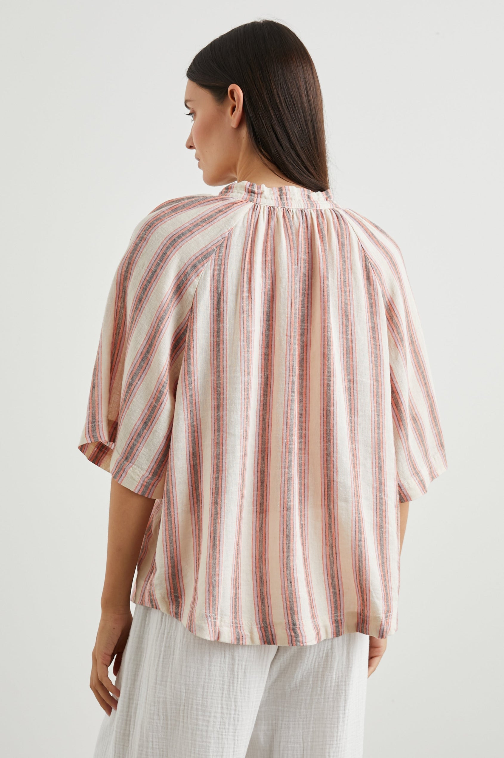Eveline Top with Elbow Length Sleeves a Deep V Neck with a Drawstring in Camino Stripe Colorway, Vertical Orange, Brown and Purple Stripes on Cream - Back View Featured on Model 