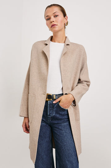 Everest Mid-Thigh Length Coat with Single Button Closure, Notched Lapels and Front Patch Pockets in Oatmeal Colorway - Front View Featured on Model