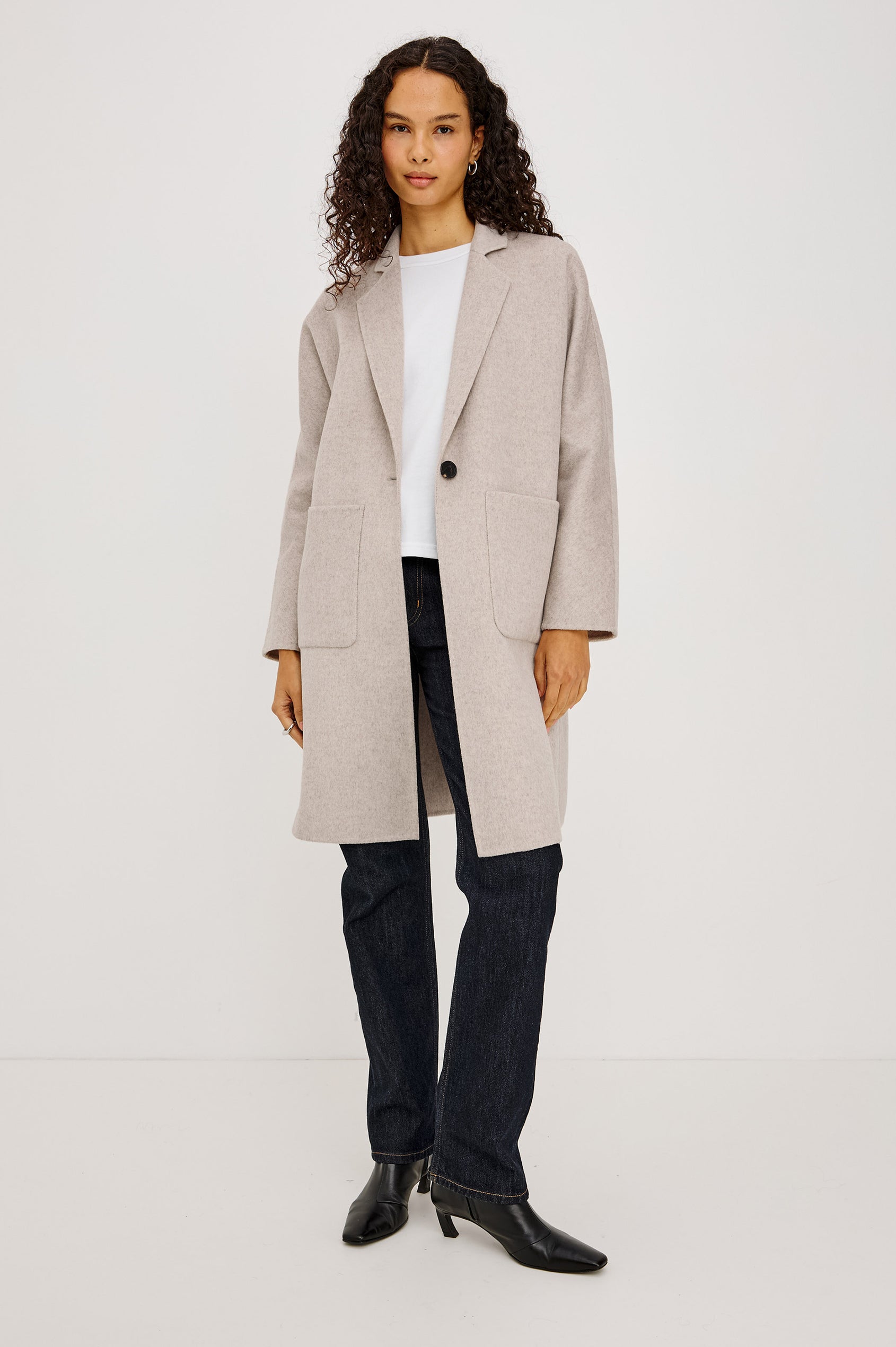 Everest Coat in Heavy Wool Blend With Longline Cut, Slightly Oversized Relaxed Fit, Lapel Collar, Single-Button Front, and Front Patch Pockets in Oatmeal Colorway - Full Body Front View Featured on Model
