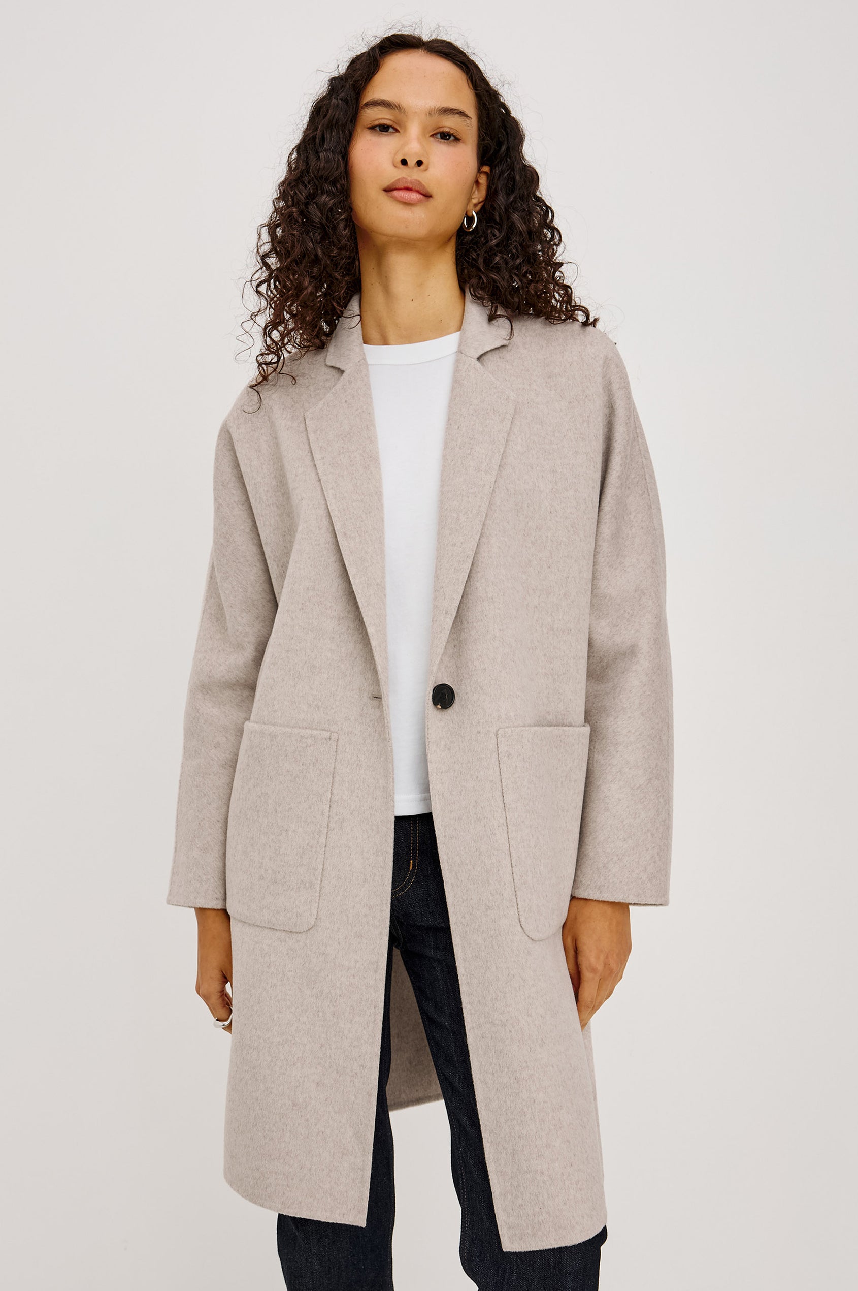Everest Coat in Heavy Wool Blend With Longline Cut, Slightly Oversized Relaxed Fit, Lapel Collar, Single-Button Front, and Front Patch Pockets in Oatmeal Colorway - Upper Body Front View Featured on Model