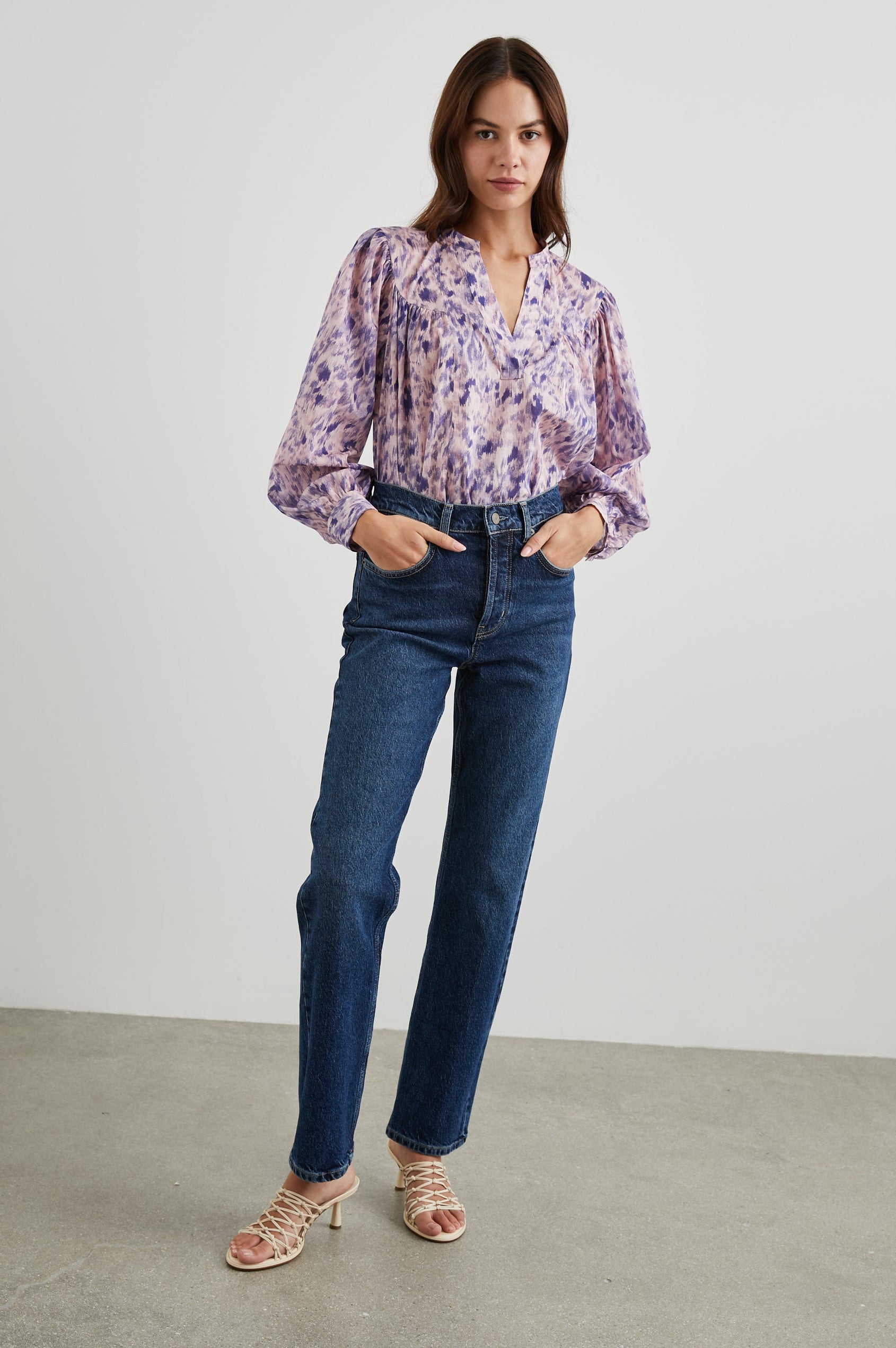 Fable Long Sleeve Top with a V Neck with a Placket, Buttoned Cuffs, and Pleating Down From the Yoke in Pink Ikat Colorway, Diffused Purple Spots on Pink - Front Tucked Full Body View Featured on Model 