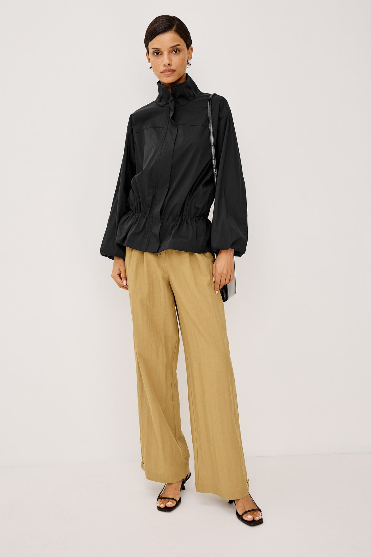 Felix Jacket in Cotton Nylon With Snap-Button Stand Collar, Front Zip-and-Snap Closures, Elastic Cuffs, Long Sleeves, and Drawcord Sides in Black Colorway - Full Body Front View Featured on Model