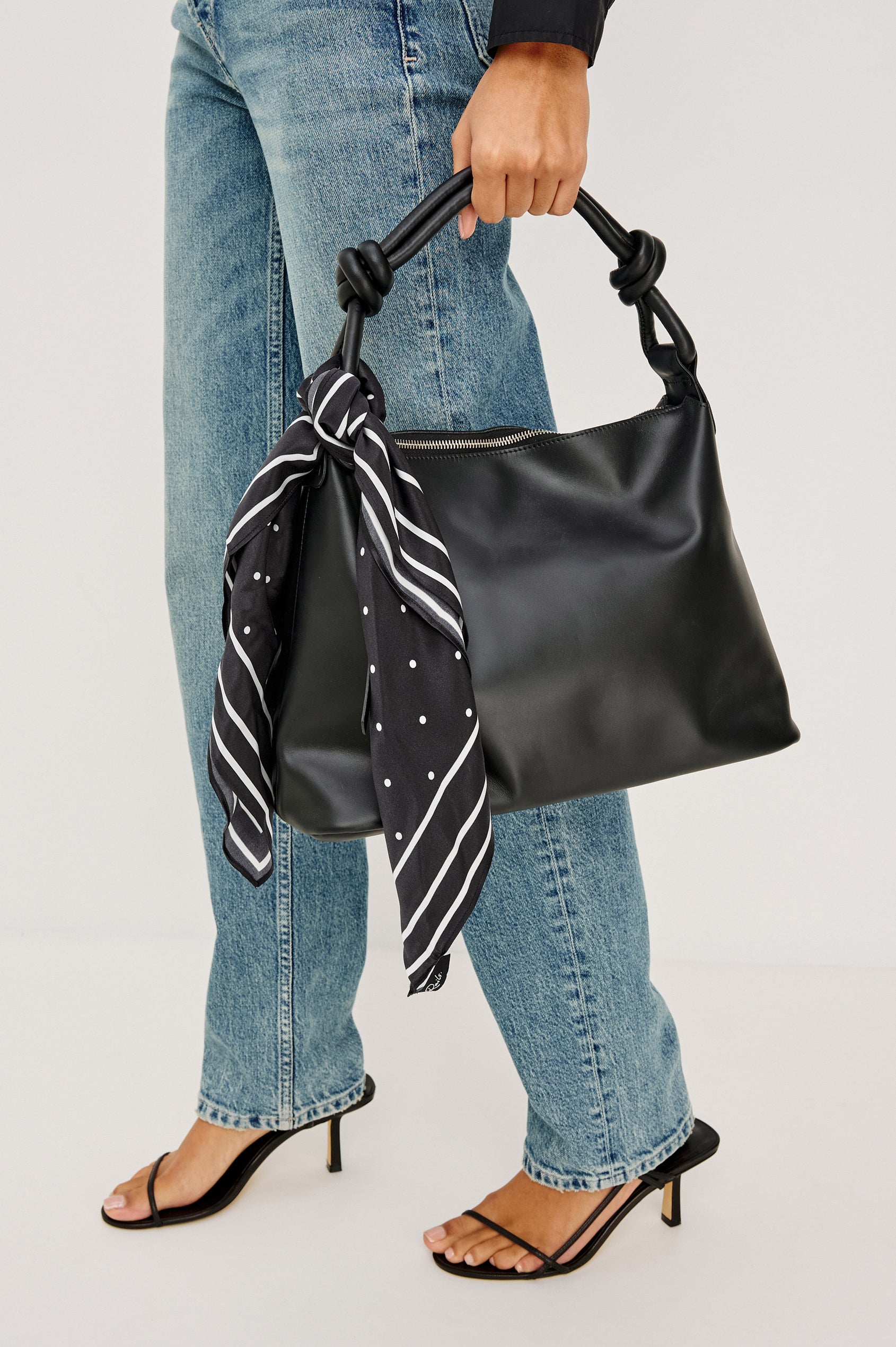 Siena Slouchy Hobo Bag in Italian Leather With Knotted Top Strap, Zipper Closure With Fringe Tassel And Interior Snap Button Slip Pocket in Black Colorway - Front View Featured