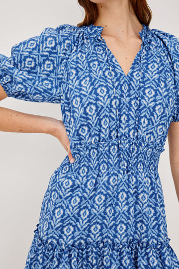 Fiorella Mini Dress in Crinkle Chiffon With Split V-Neck and Adjustable Ties Short Puff Sleeves Shirred Waist and Lined Tiered Skirt in Blue Ikat Colorway - Upper Body Close Up View Featured on Model