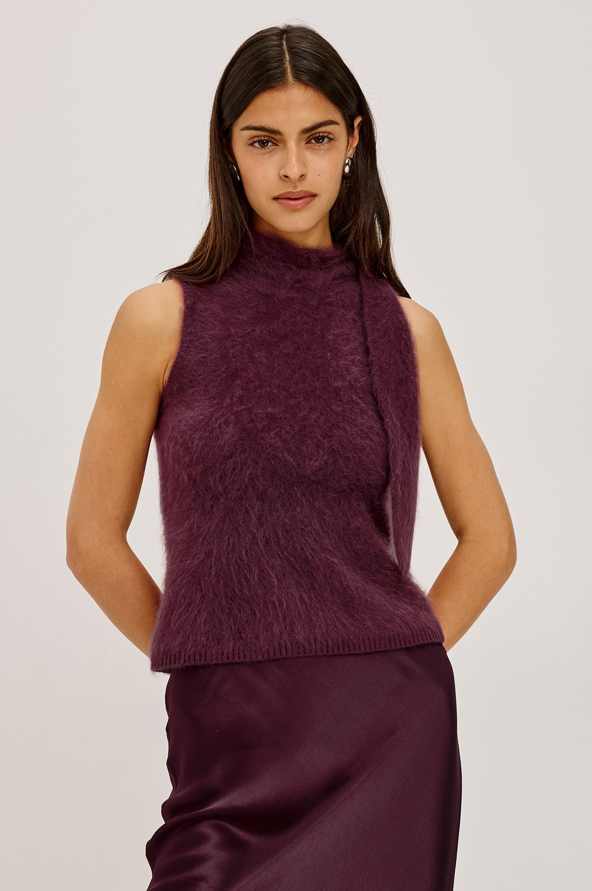 Flora Top in Brushed Knit With Mock Neck, Tie Detail, and Sleeveless Silhouette in Wine Colorway - Upper Body Front View Featured on Model.