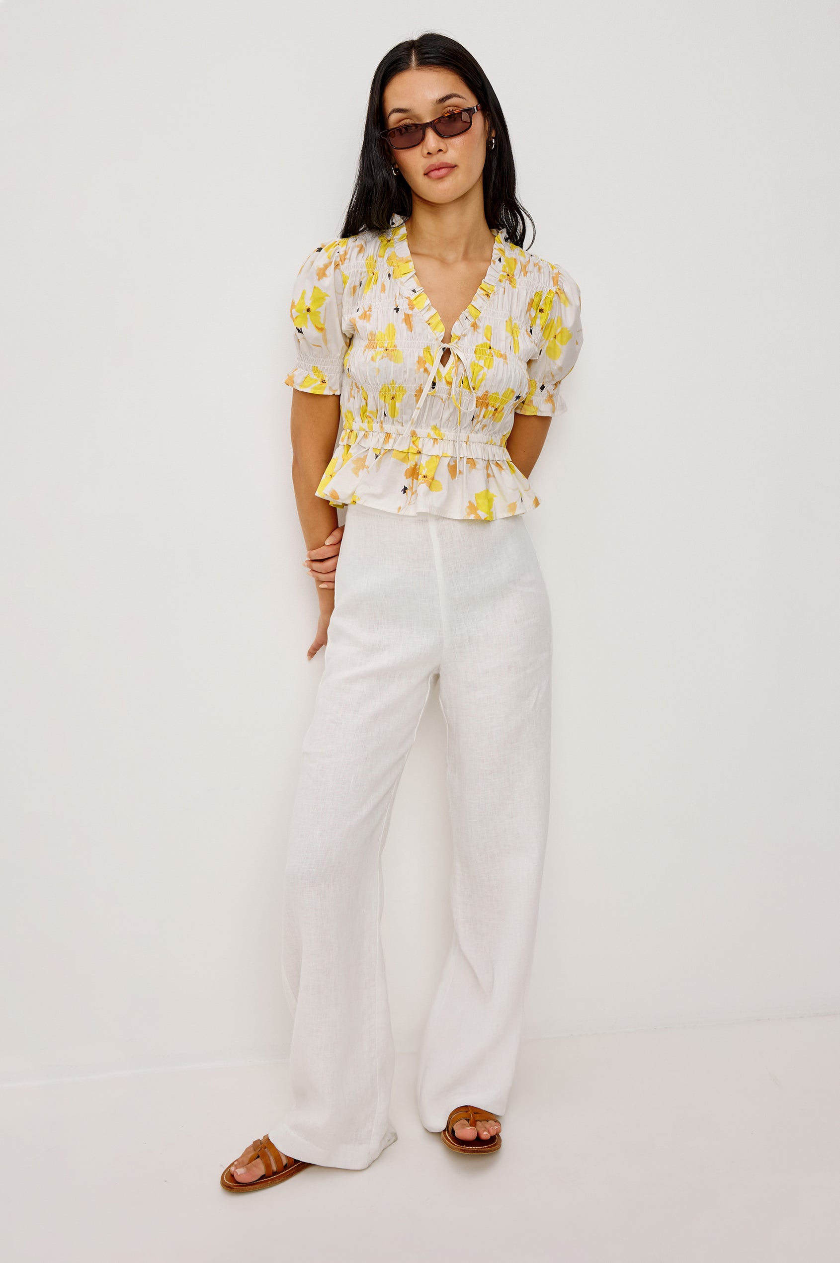 Fontaine Cropped Top in Cotton Poplin With Fitted Smocked Body V-Neckline With Center-Front Ties Short Puff Sleeves Rufle Trim and Peplum Hem in Tossed Daffodils Colorway - Full Body Front View Featured on Model