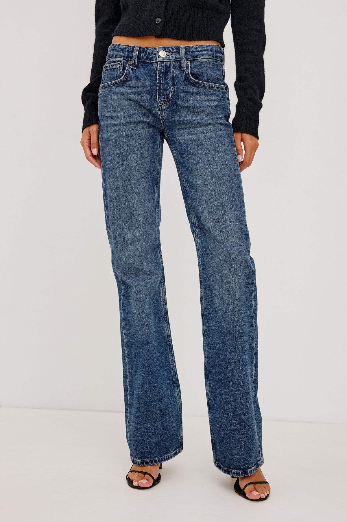 Fremont Low Rise Bootcut Jean in Light Stretch Denim With Extended Inseam, 5-Pockets, Belt Loops, and Zip-Fly Closure in Blue Haven Colorway - Upper Body Front View Featured on Model.