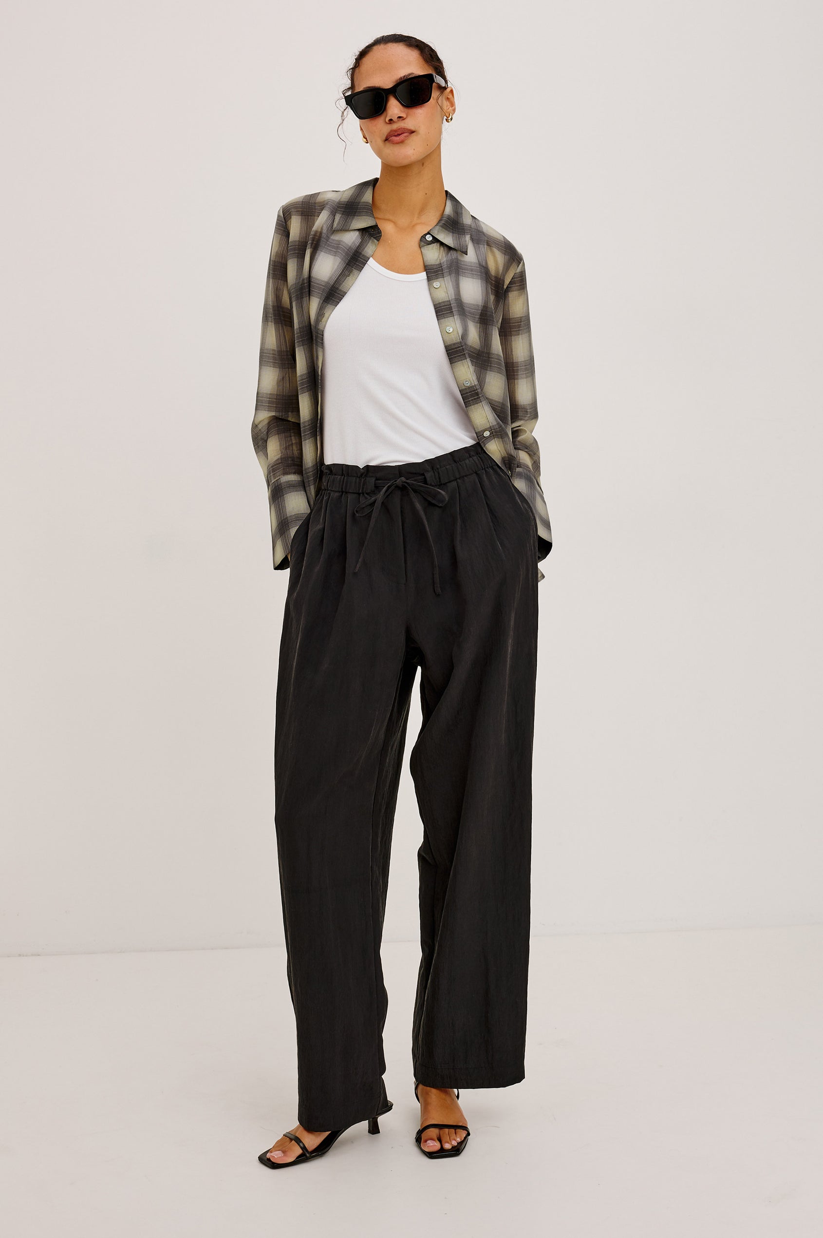 Fulham Pant in Nylon With Mid-Rise Wide Leg Fit, Front Pleats, Back Patch Pockets, Back Hem Buttons to Adjust Leg Wide to Slim in Black Colorway - Lower Body Front View Featured on Model