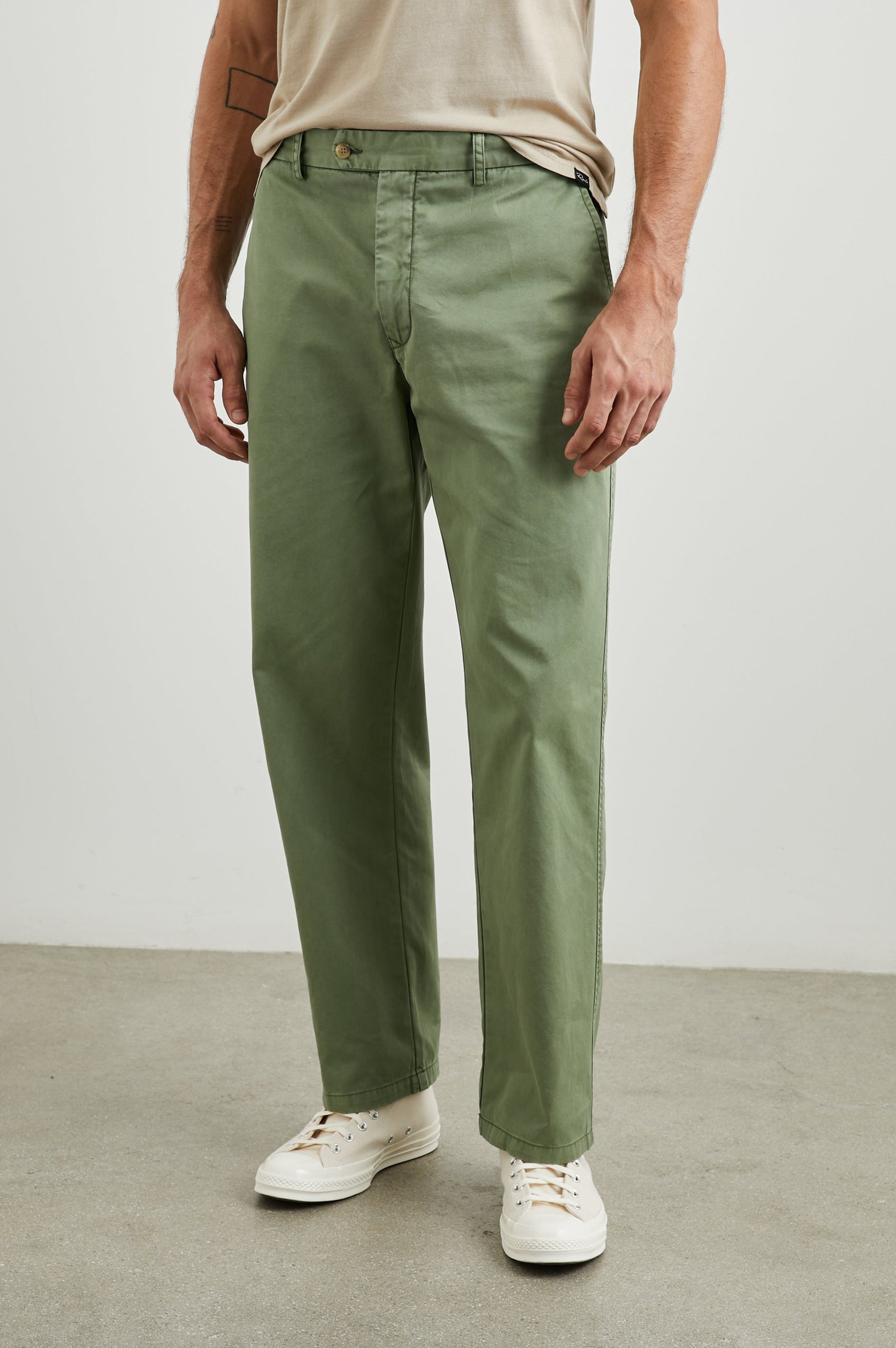 Garrett Pants with a Button Strap Closure at the Waist, Belt Loops, Two Front Pockets and Two Back Button Welt Pockets in Spring Olive Colorway - Front View Featured on Model