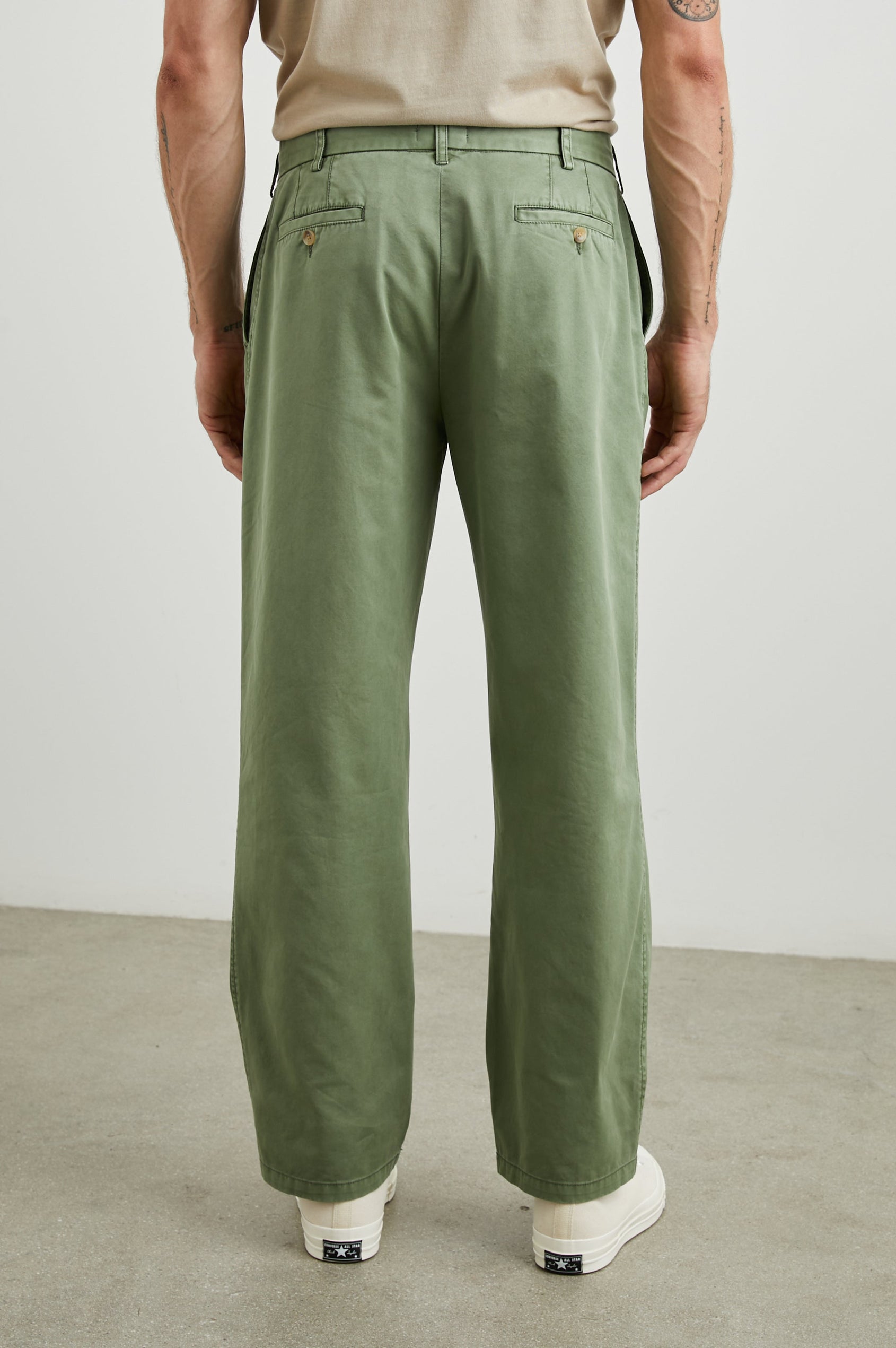 Garrett Pants with a Button Strap Closure at the Waist, Belt Loops, Two Front Pockets and Two Back Button Welt Pockets in Spring Olive Colorway - Back View Featured on Model