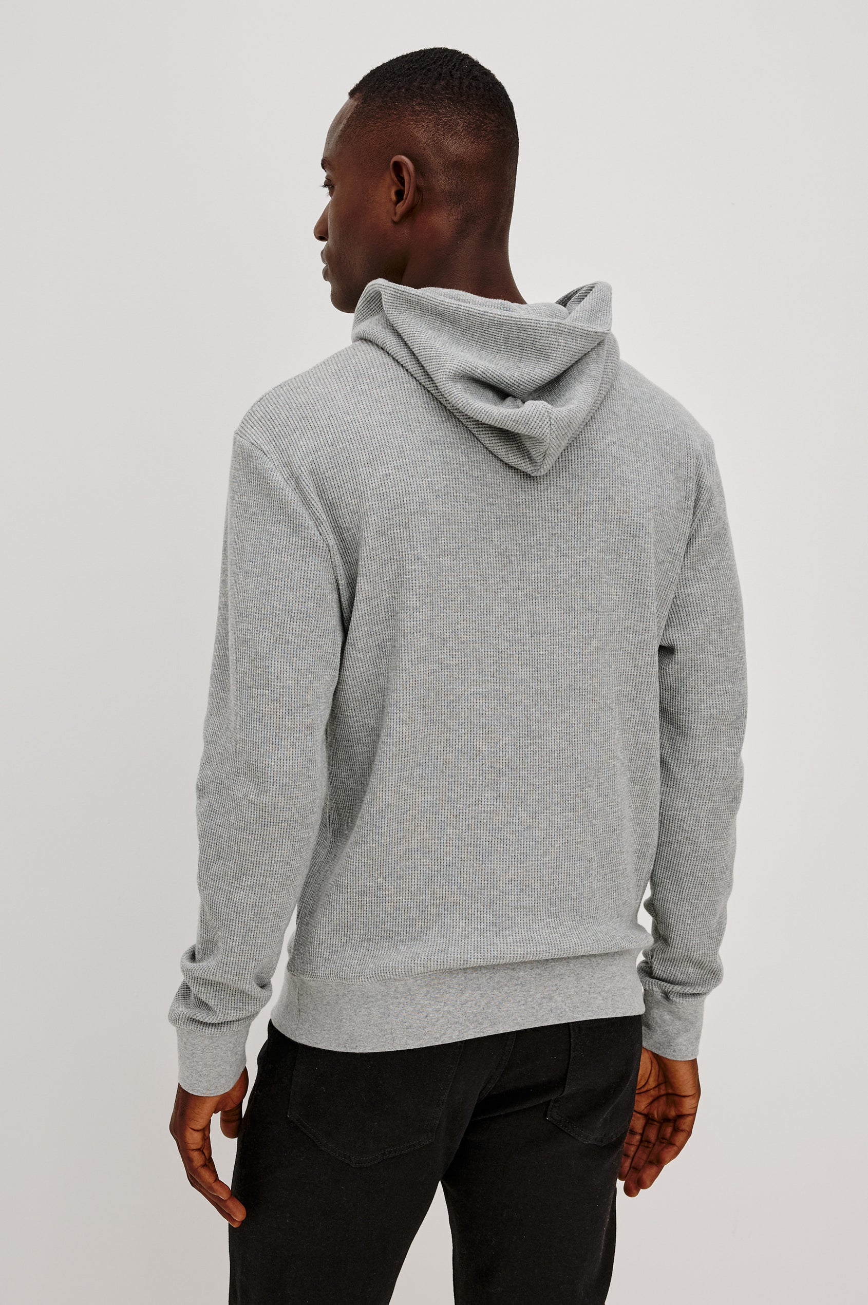 Gates Hoodie in Micro-Waffle Cotton Blend With Fixed Hood, Long Sleeves, and Relaxed Fit in Heather Grey Colorway - Upper Body Back View Featured on Model