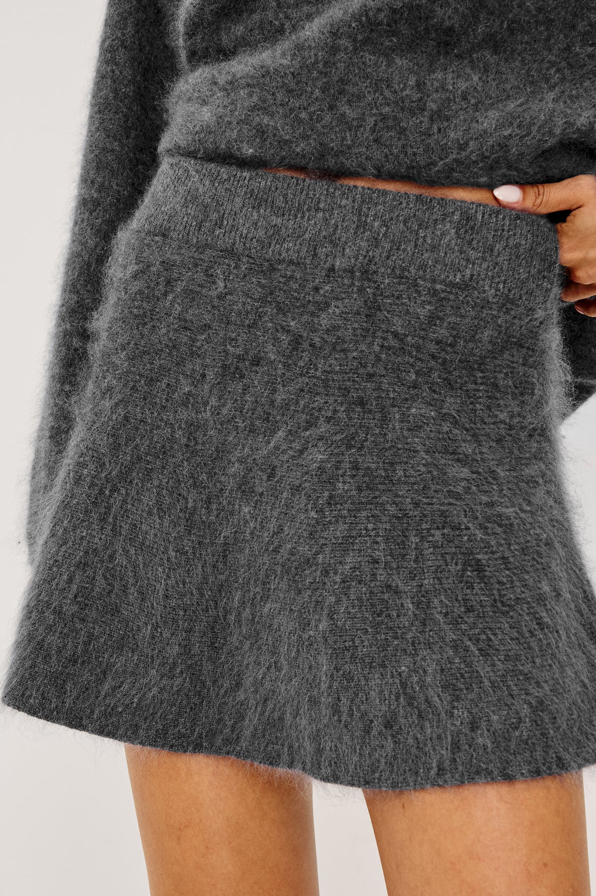 Gayle Mini Skirt in Brushed Wool With High Waist and A-Line Shape in Charcoal Colorway - Upper Body Front View Featured on Model