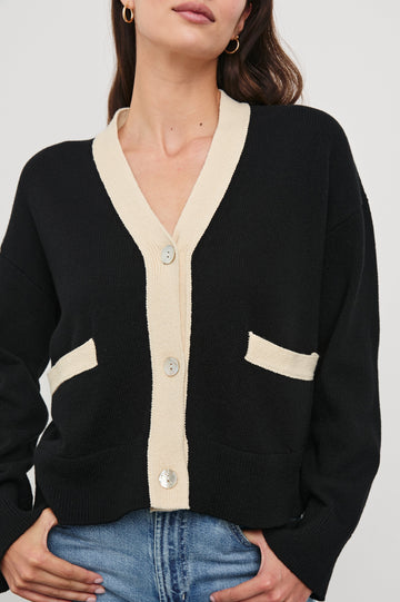 Geneva Long-Sleeve Cardigan with Two Front Patch Pockets and Button Closure in Black Ivory Colorway, with Ivory neckline, closure and pocket openings on Black - Front View Featured on Model