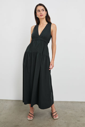 Genevieve Midi Tank Dress with Low V-Neck, Encased Elastic Waistband, Back Waist Cutout and Tiered A-Line Skirt in Black Colorway. Full Body Front View Shown on Model.