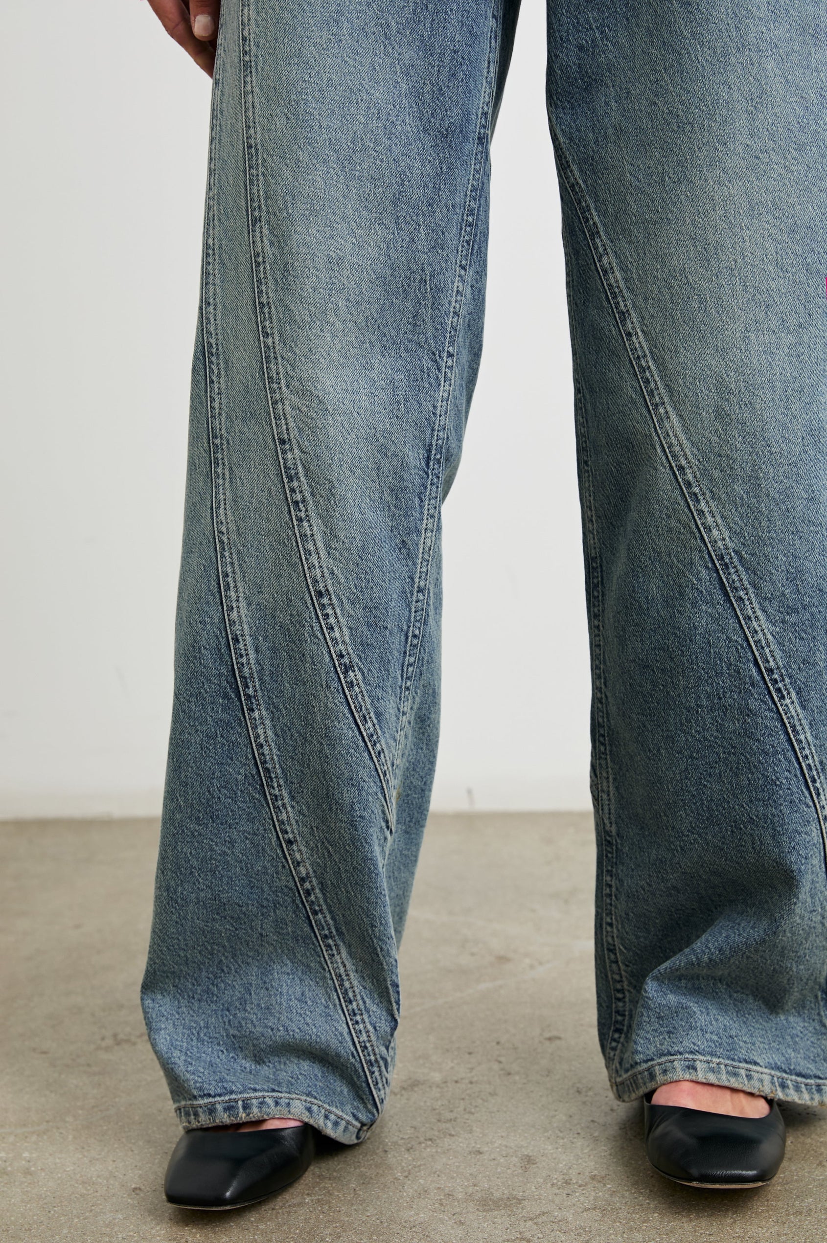 Getty Twist Seam Wide Leg Denim Pants with a Diagonal Seam Across the Leg, Belt Loops, Two Front Pockets and Two Back Patch Pockets in Desert Sky Colorway - Front View Featured on Model