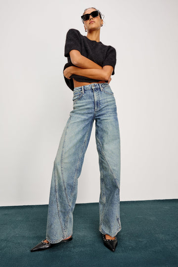 Getty Twist Seam Wide Leg Denim Pants with a Diagonal Seam Across the Leg, Belt Loops, Two Front Pockets and Two Back Patch Pockets in Desert Sky Colorway - Full Body Front View Featured on Model