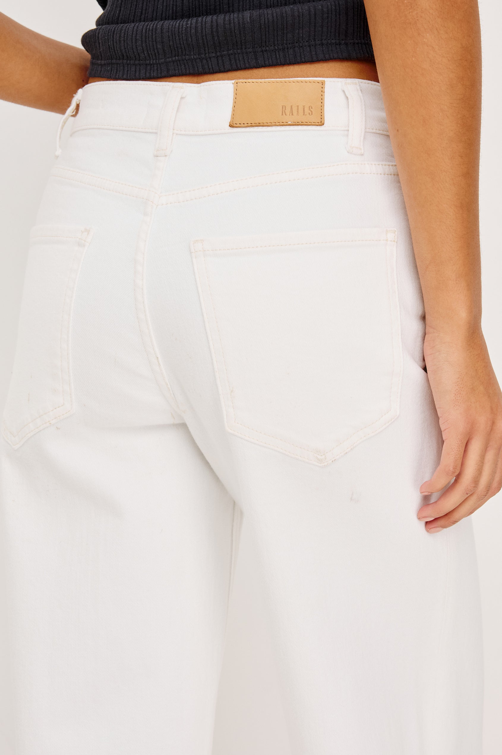 Getty Wide Leg Jean in Light Stretch Denim With High-Rise High-Waisted Fit, Button Fly, and 5-Pocket Styling in Vintage Ecru Colorway - Lower Body Back View Featured on Model