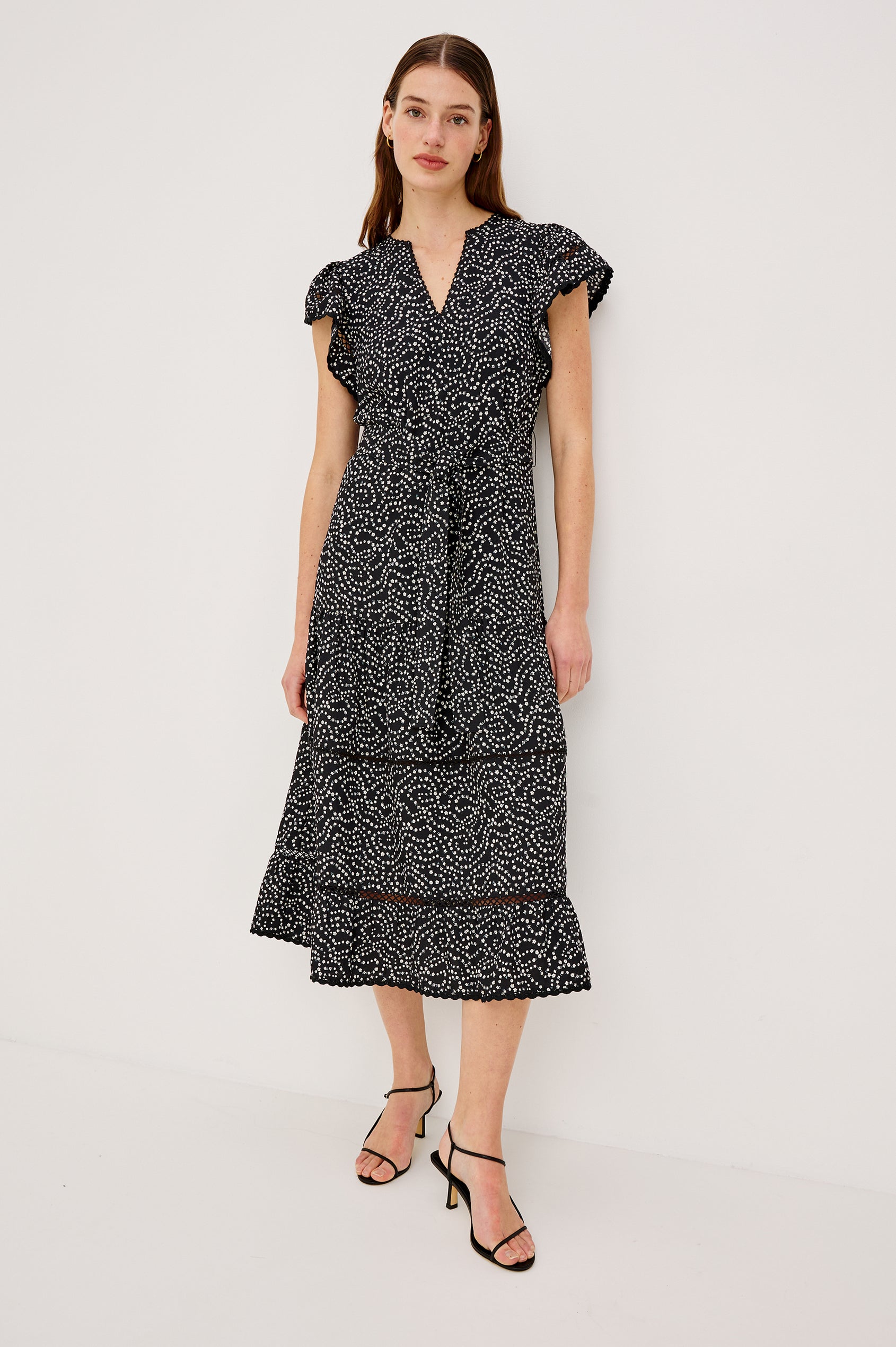 Gia Midi Dress in Crinkle Poplin With Adjustable Waist Ties Split V-Neck Collar Wide Short Sleeves Ladder and Crochet Trim Detailing and Relaxed FIt in Mini Chain Daisies Colorway - Full Body Front View Featured on Model