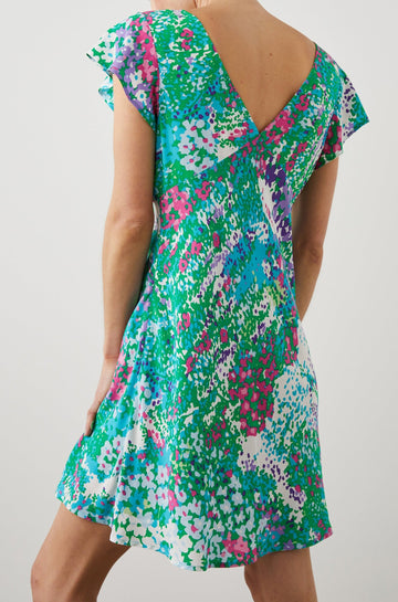 Gigi Short Sleeve Mini Dress with a Deep V Neck, and Flutter Sleeves in Gardenia Floral Colorway, Greens, Blues, Purples, Pink and White - Back View Featured on Model 