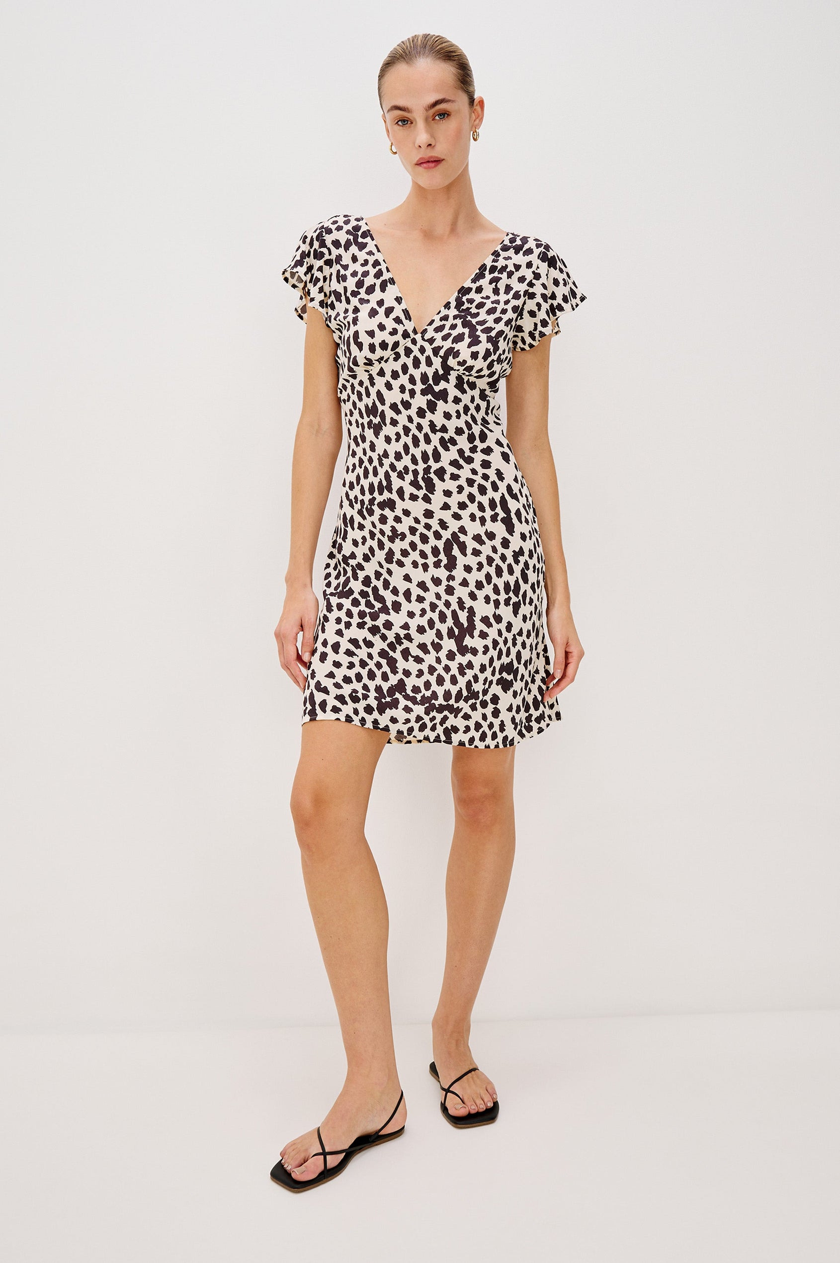 Gigi V-Neck Mini Dress with Short Flutter Sleeves, Empire Waist  in Taupe Spotted Colorway. Full Body Front View Shown on Model.