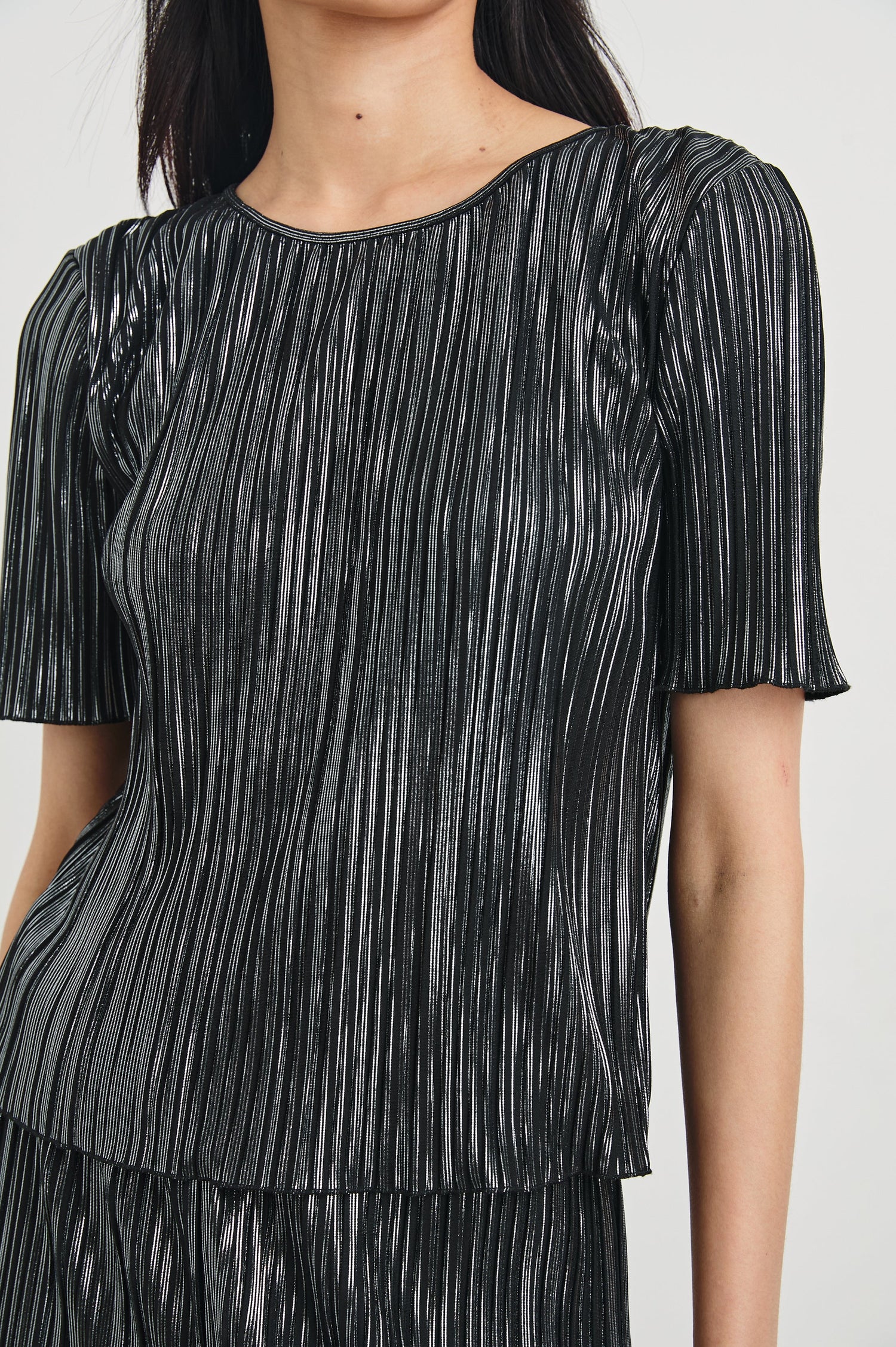 Goldie Short Sleeve Top with a Crew Neck in Gunmetal Colorway, with Thin Vertical Stripes of Back, White and Greys - Front View Featured on Model