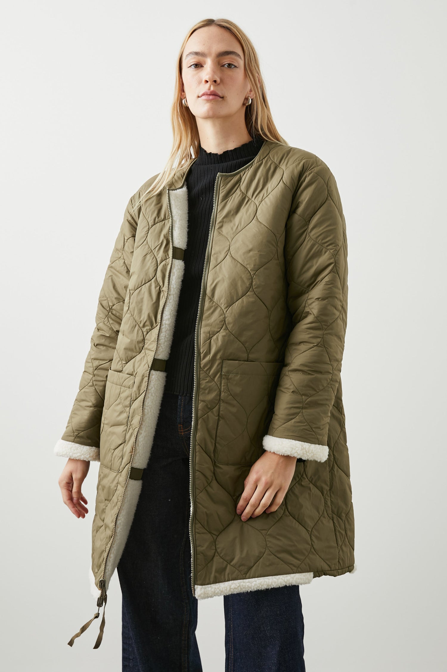 Granger Knee-Length Reversible Jacket with Zip Closure, One Side Quilted with Two Front Patch Pockets, the Reverse Side Ivory Sherpa Fleece with Olive Quilted Horizontal Bands in Ivory Olive Mix Colorway - Front Quilted View Featured on Model
