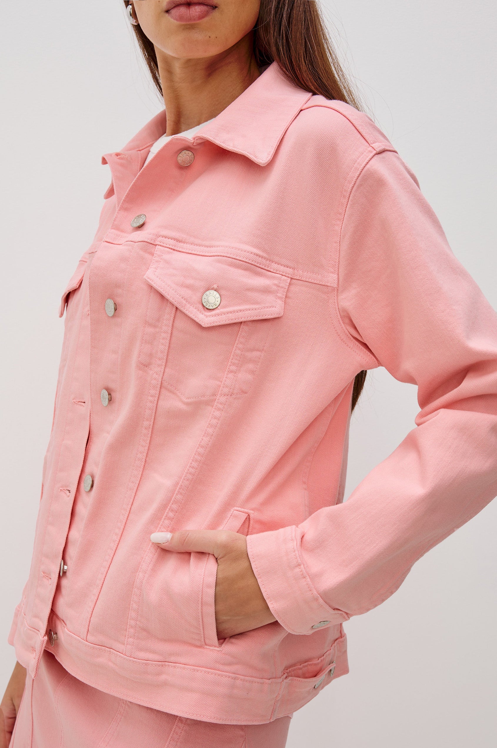 Grove Denim Trucker Jacket with Button Front and Chest Flap Pockets in Bubblegum Colorway. Front Detail View of Model Shown.