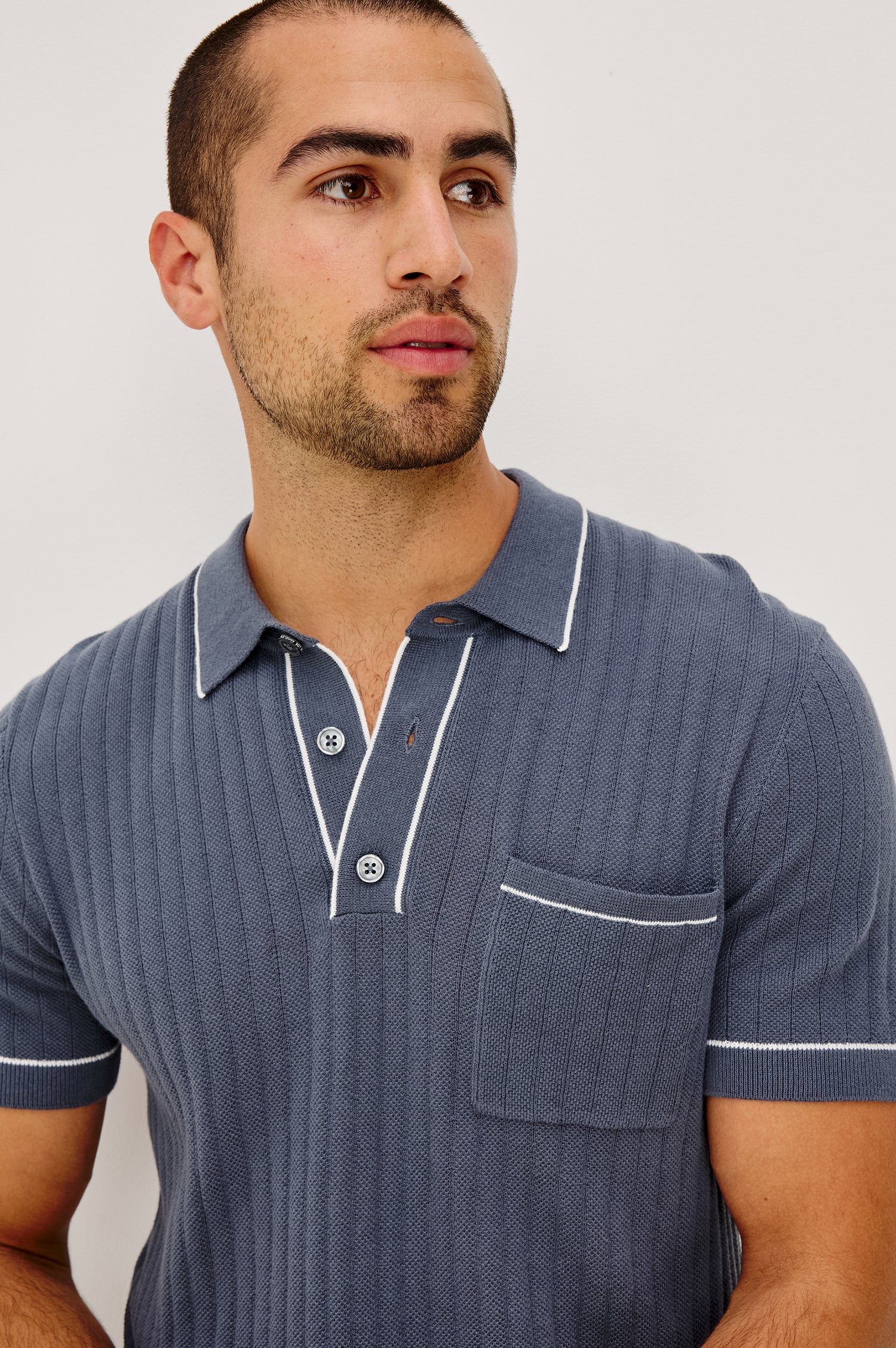 Hardy Polo Shirt in Luxe Cotton Rib Knit With Collar, Half Button Placket, Short Sleeves, and Contrast Trim in Faded Navy Colorway - Upper Body Front View Featured on Model