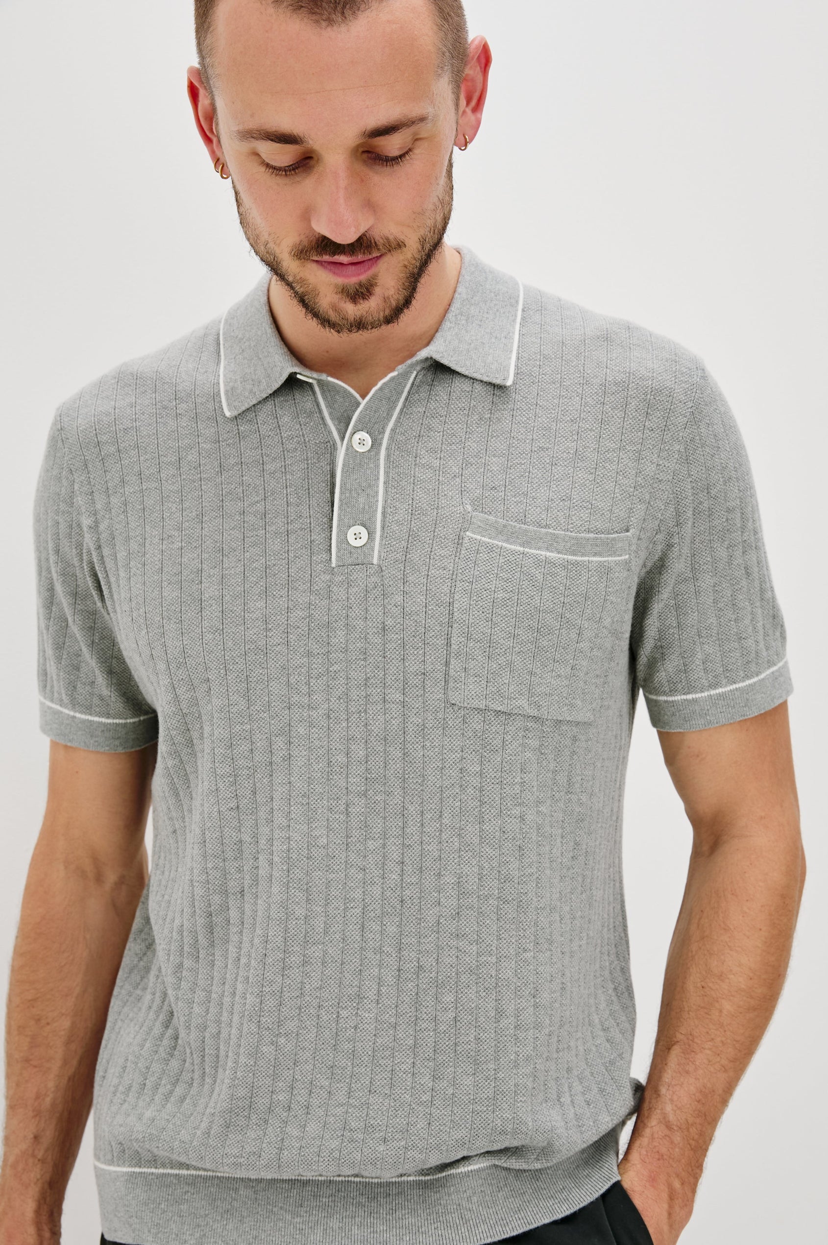 Hardy short sleeve cotton rib polo with chest pocket, two button placket and contrast stitching in Grey Melange - front close up on model looking down
