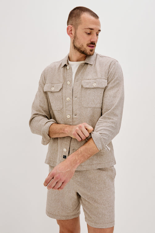 Hayes Shirt Jacket with Long Sleeves and Chest Flap Pockets with Button Closure, Exposed Button Front in Blue Mirage. Front View Shown on Model.