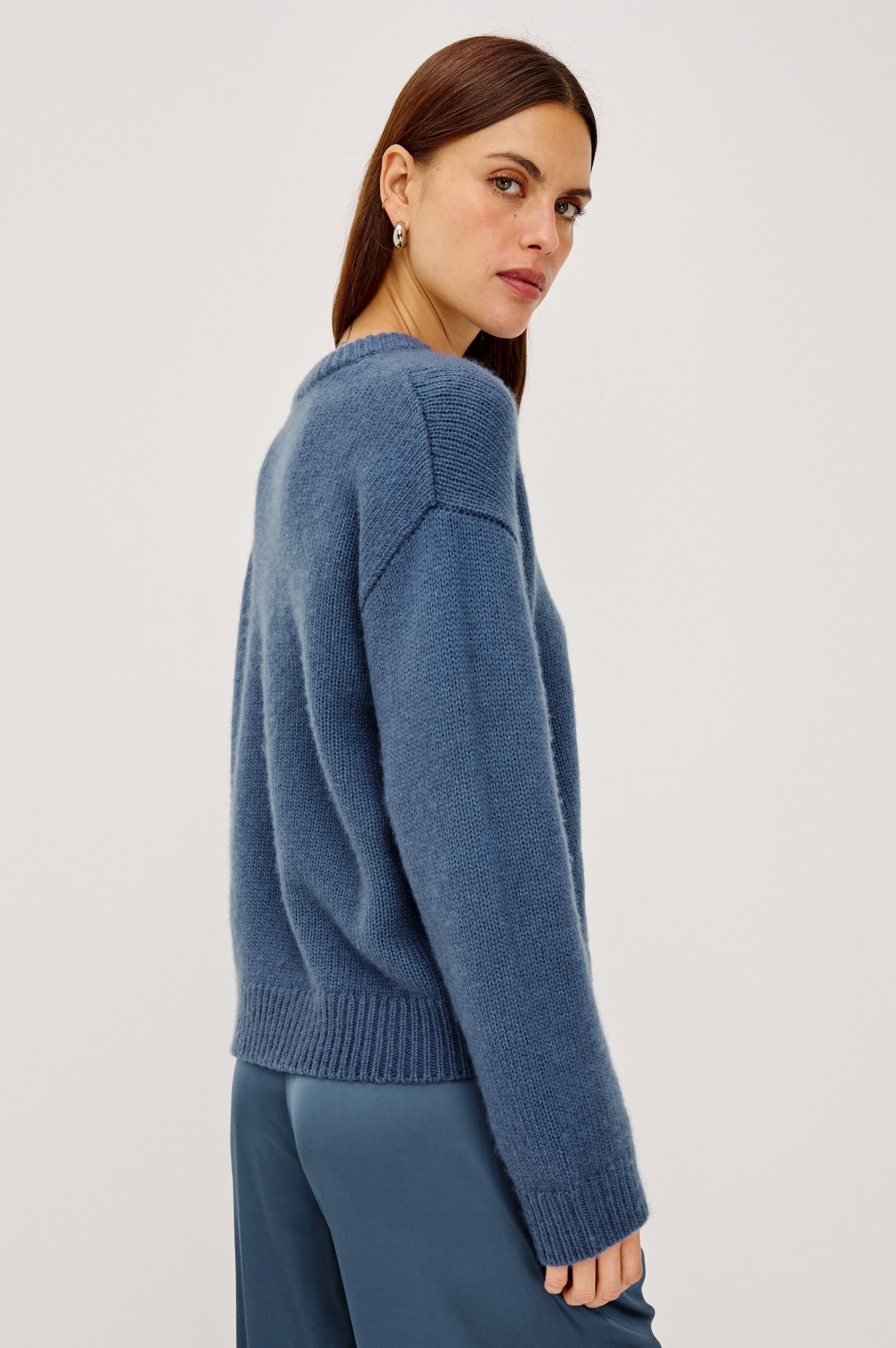Helly Sweater in Wool-Cashmere Blend With Crew Neckline, Relaxed Boxy Slightly Cropped Fit, Long Sleeves, and Ribbed Trim in Atlantic Colorway - Upper Body Side View Featured on Model