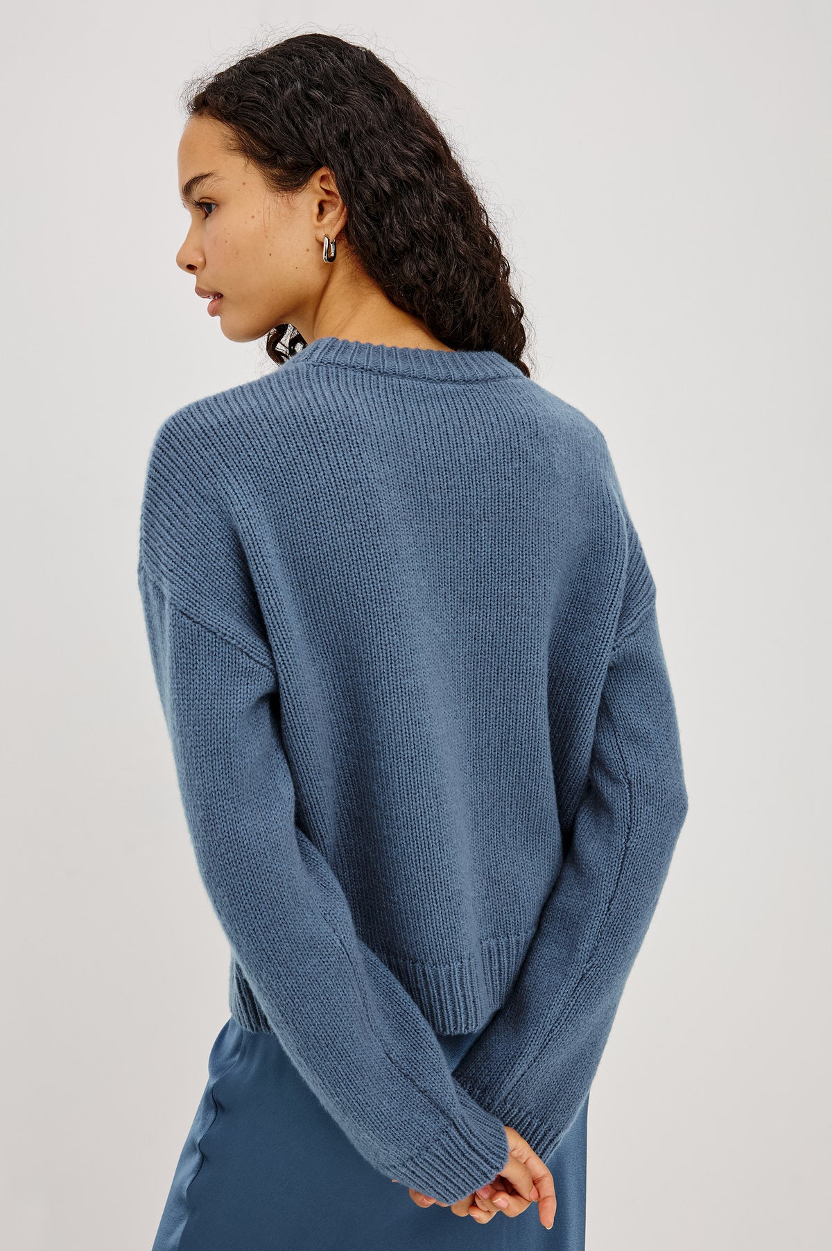 Helly Sweater in Wool-Cashmere Blend With Crew Neckline, Relaxed Boxy Slightly Cropped Fit, Long Sleeves, and Ribbed Trim in Atlantic Colorway - Upper Body Side View Featured on Model