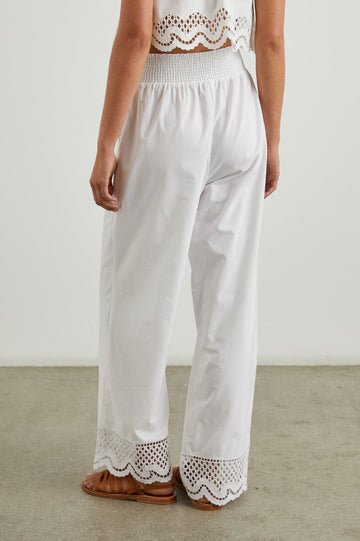 Henrik Pants with a Shirred Waist, Two Front Pockets and an Eyelet Design at the Hems in White Colorway - Back View Featured on Model 