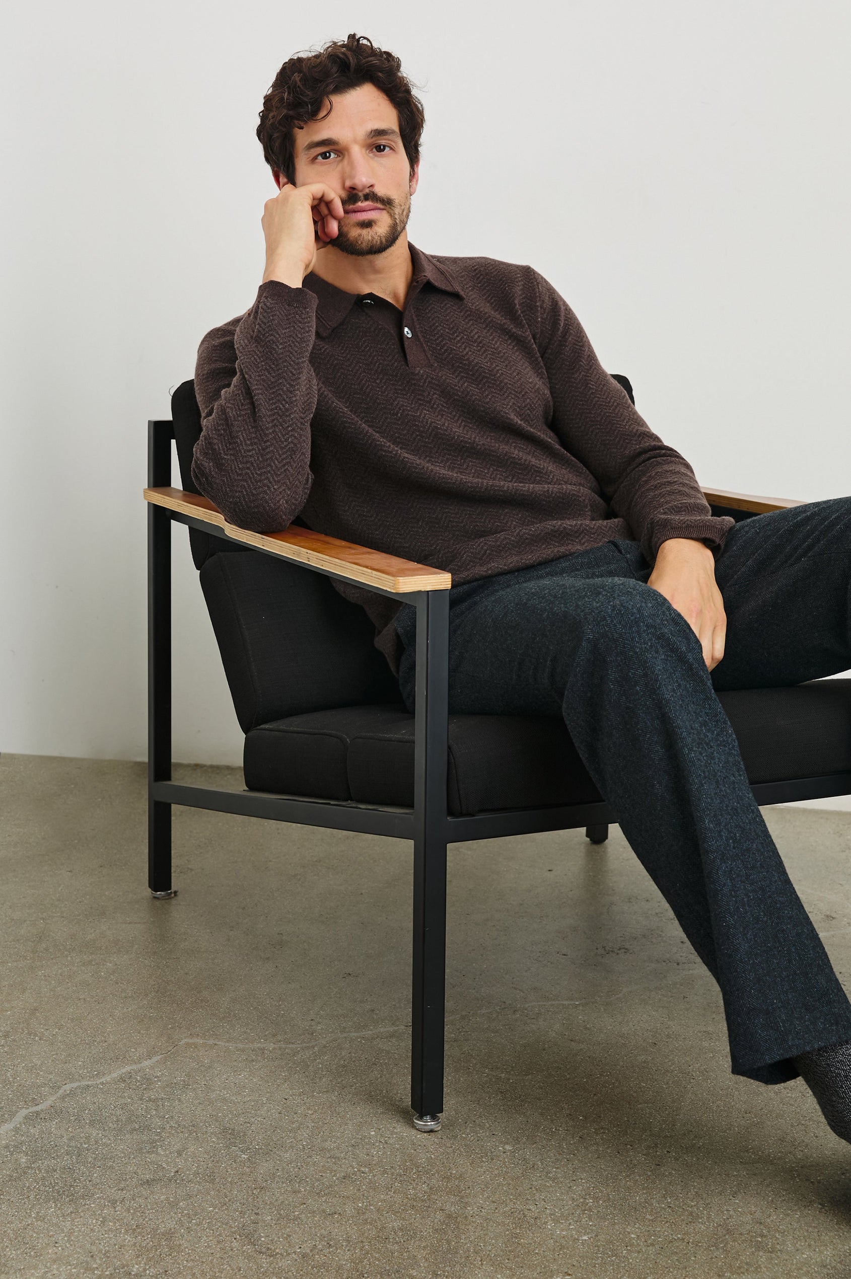 Herrington Long-Sleeve Collared Sweater with a Two Button Placket and a Herringbone Jacquard in Brown Herringbone Melange Colorway - Front Full Body View Featured on Seated Model