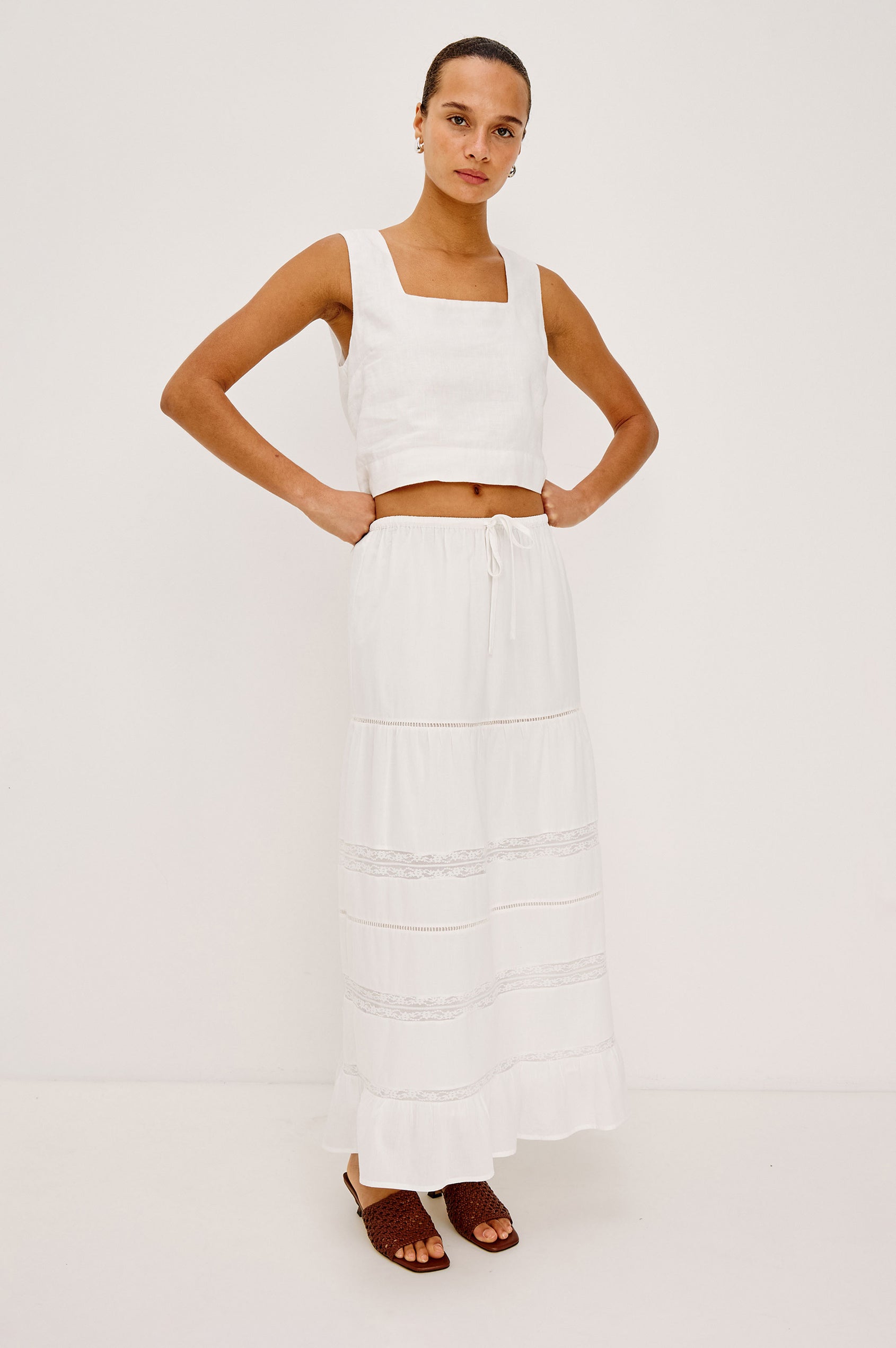 Hettie High-Waisted Maxi Skirt in Cotton Voile With Ladder Trim, Lace Insets, Self-Tie Waist, Relaxed Fit, and Fully Lined in White Colorway - Full Body Front View Featured on Model
