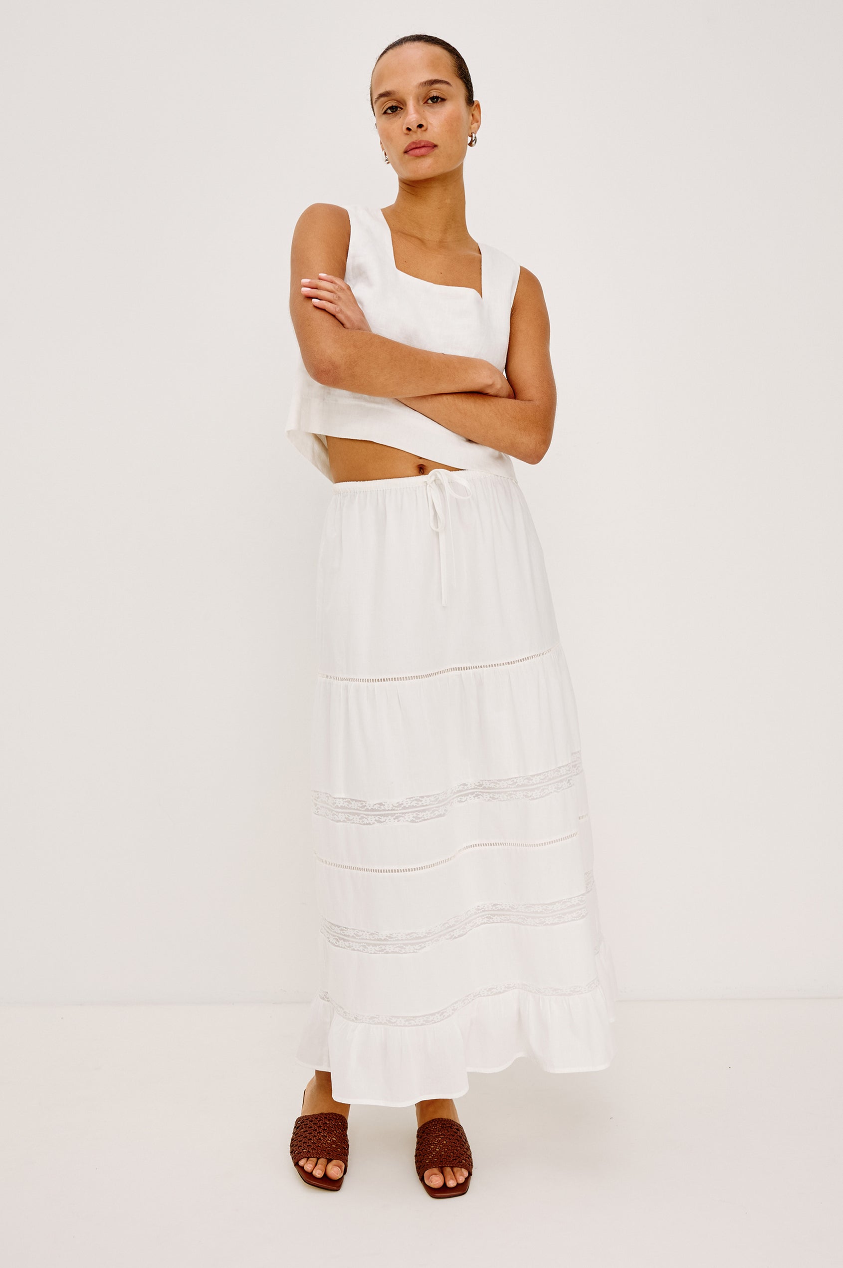 Hettie High-Waisted Maxi Skirt in Cotton Voile With Ladder Trim, Lace Insets, Self-Tie Waist, Relaxed Fit, and Fully Lined in White Colorway - Full Body Front View Featured on Model