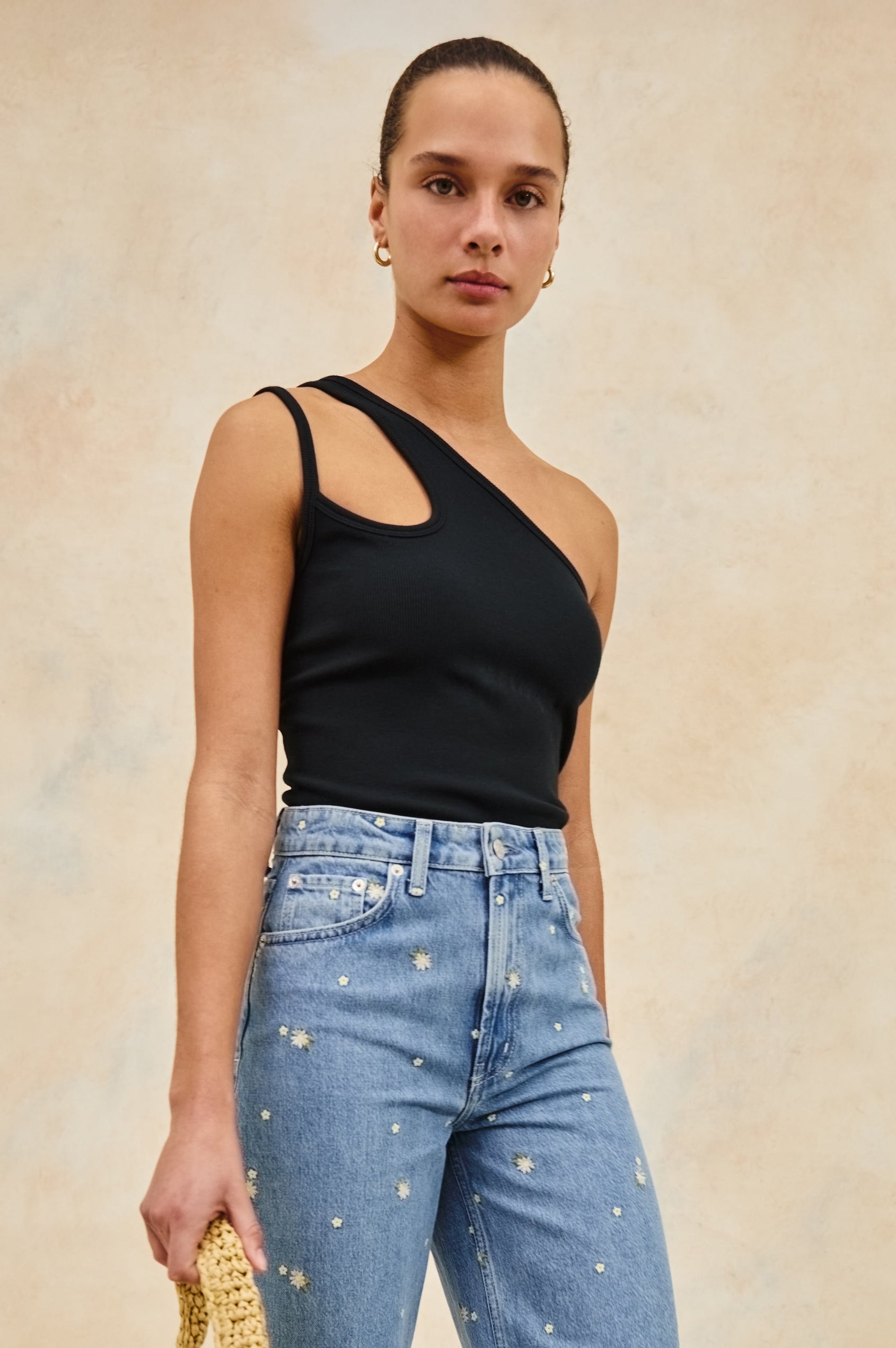 Hira asymmetrical tank top with keyhole sleeve feature in Black - stylized front view on model