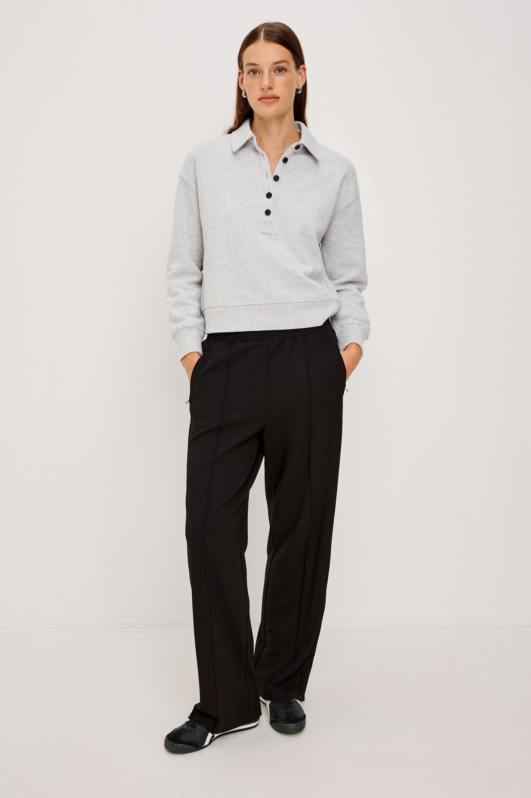 Black ponte pull-on pants with an elastic waistband. The pants feature functional ankle zippers that can be opened to create a subtle flare. Full Body Front View on Model.